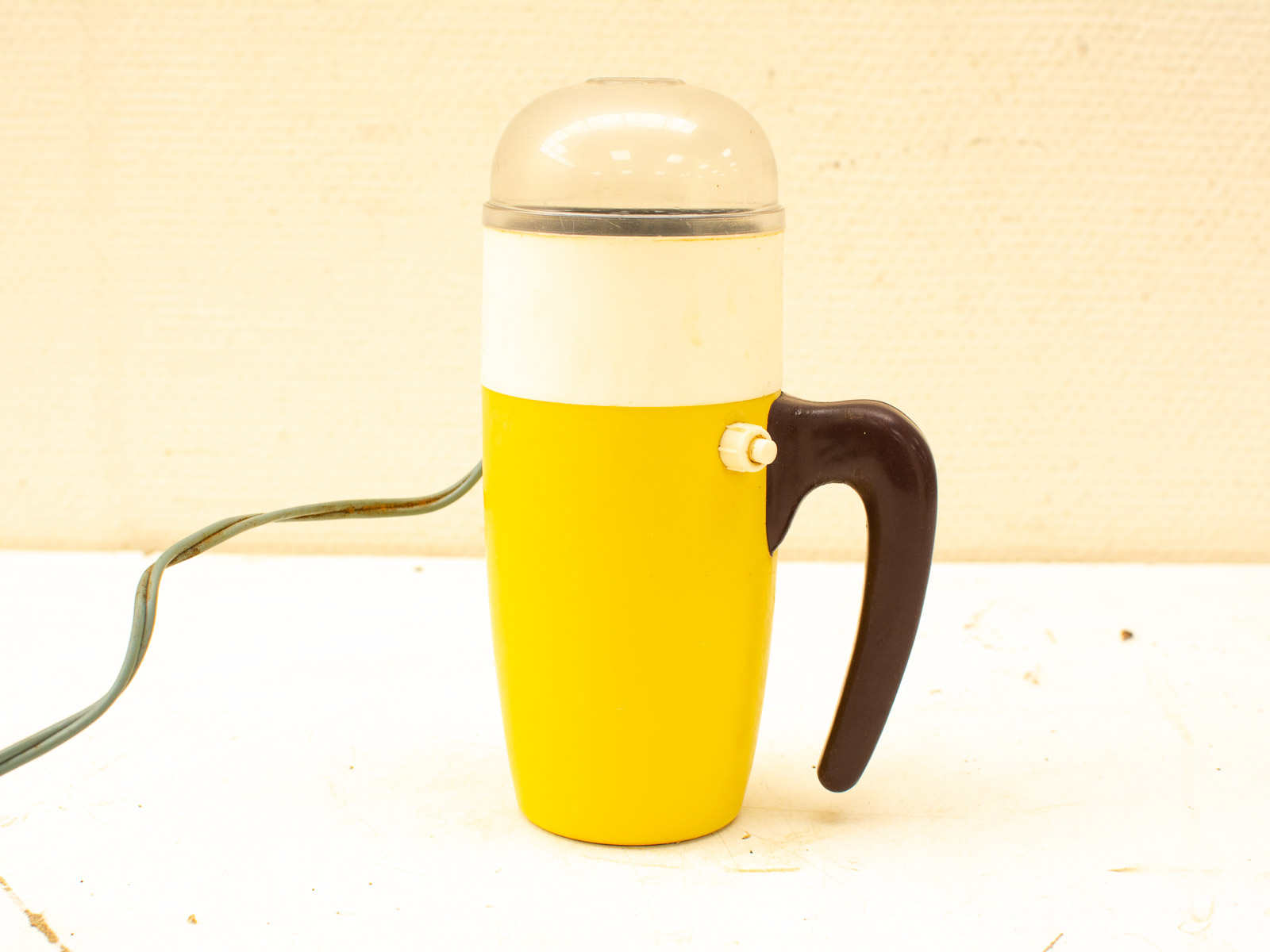 Charming retro yellow electric beverage maker for coffee and hot chocolate, perfect for nostalgic kitchens.