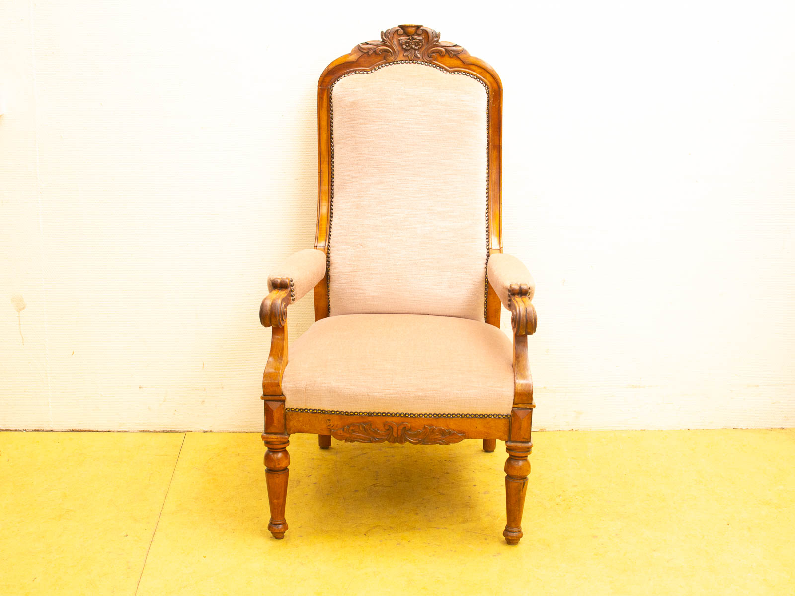 Elegant vintage armchair with wooden frame and soft beige upholstery, perfect for stylish interiors.