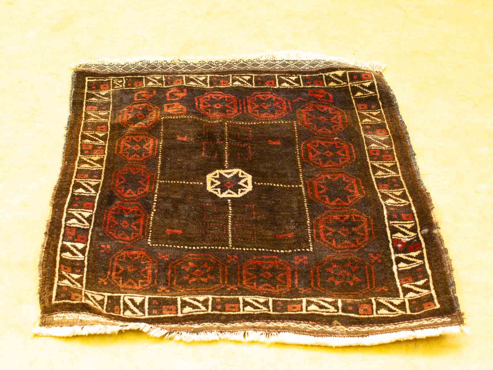 Handwoven vintage rug with star design and geometric patterns, adding warmth and cultural charm.