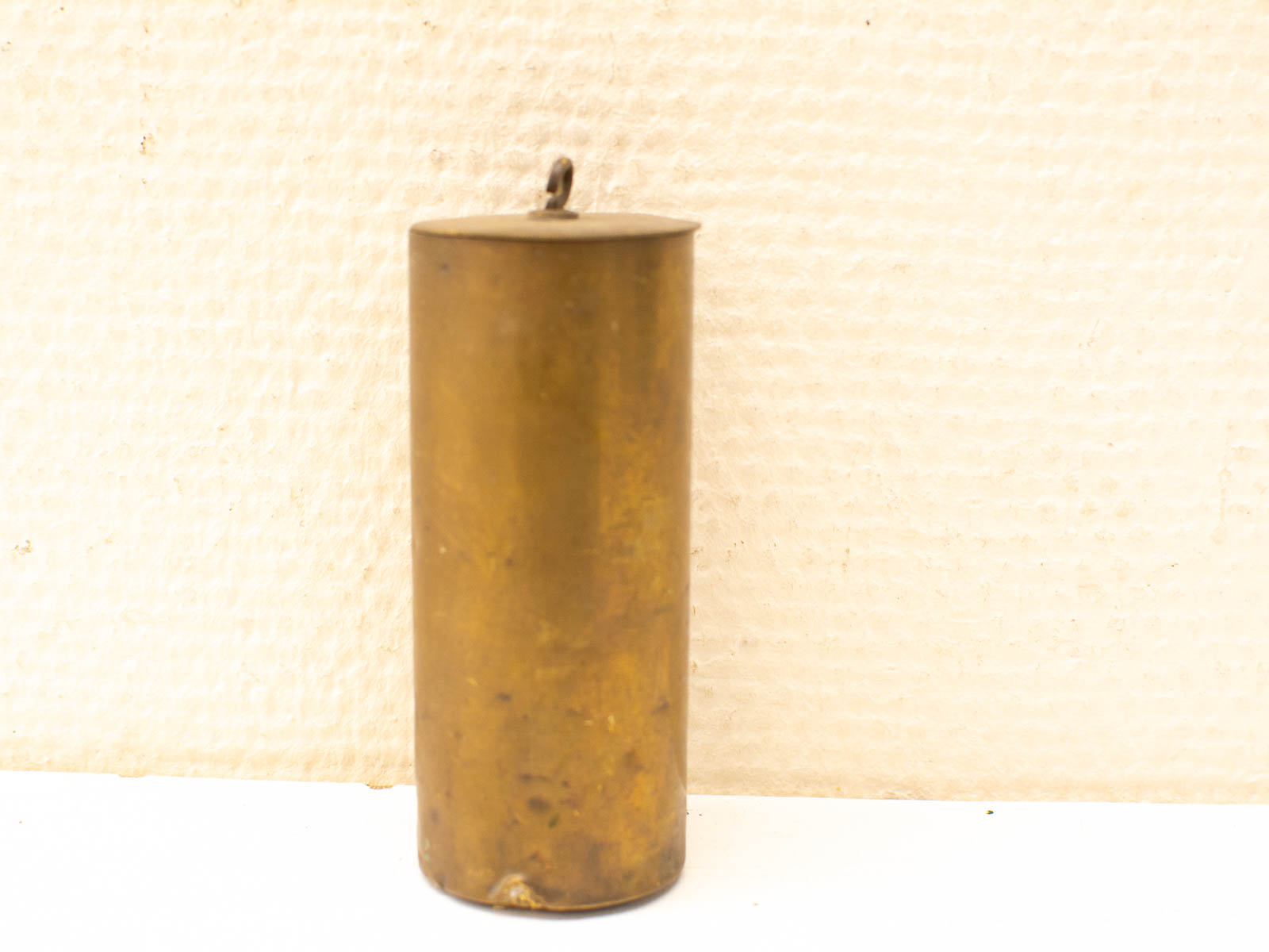 Vintage brass cylinder with lid, embodying timeless design and unique character for home decor.