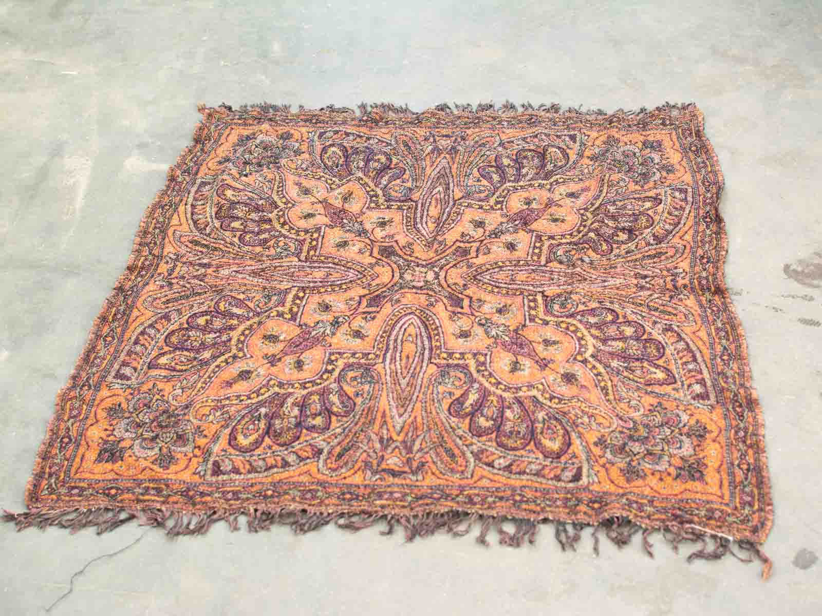 Stunning vintage Persian shawl in vibrant orange and purple, featuring intricate floral patterns.