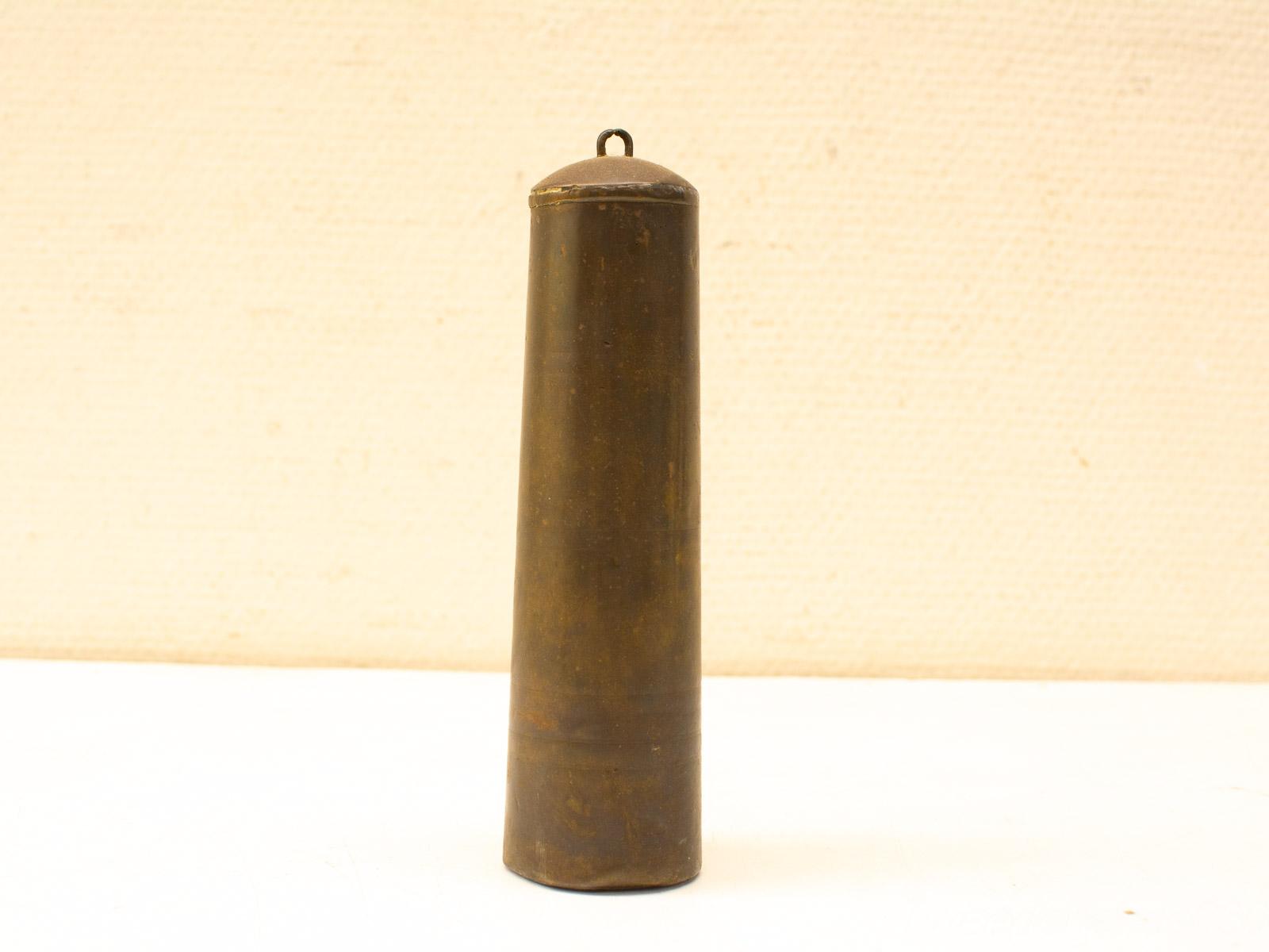 Antique metal cylinder with rich patina, showcasing exquisite craftsmanship and unique vintage design.