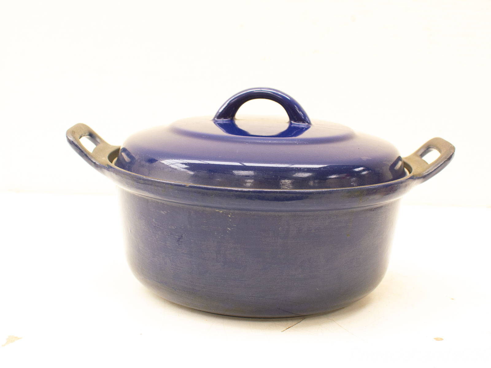 Vintage deep blue enamel soup pot with lid, perfect for stews and stylish kitchen decor.