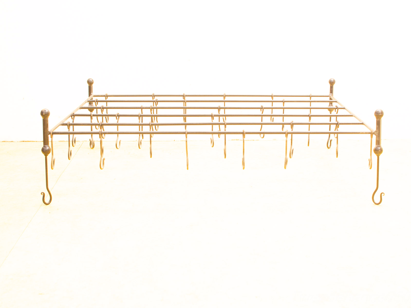 Vintage metal rack with elegant hooks, ideal for hanging clothes and enhancing home decor.