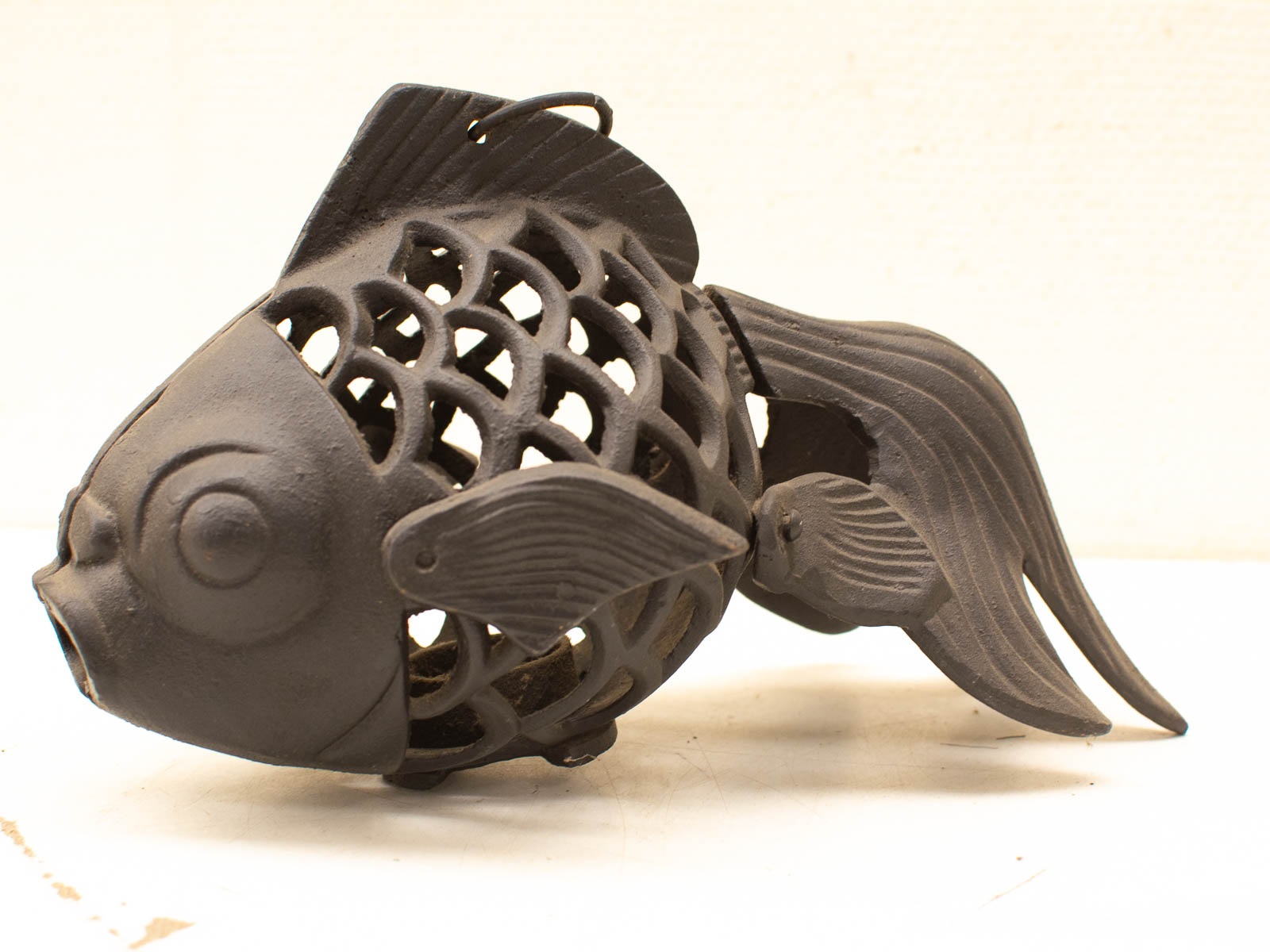 Intricate vintage fish sculpture with lattice design, ideal as a decorative accent or lantern holder.