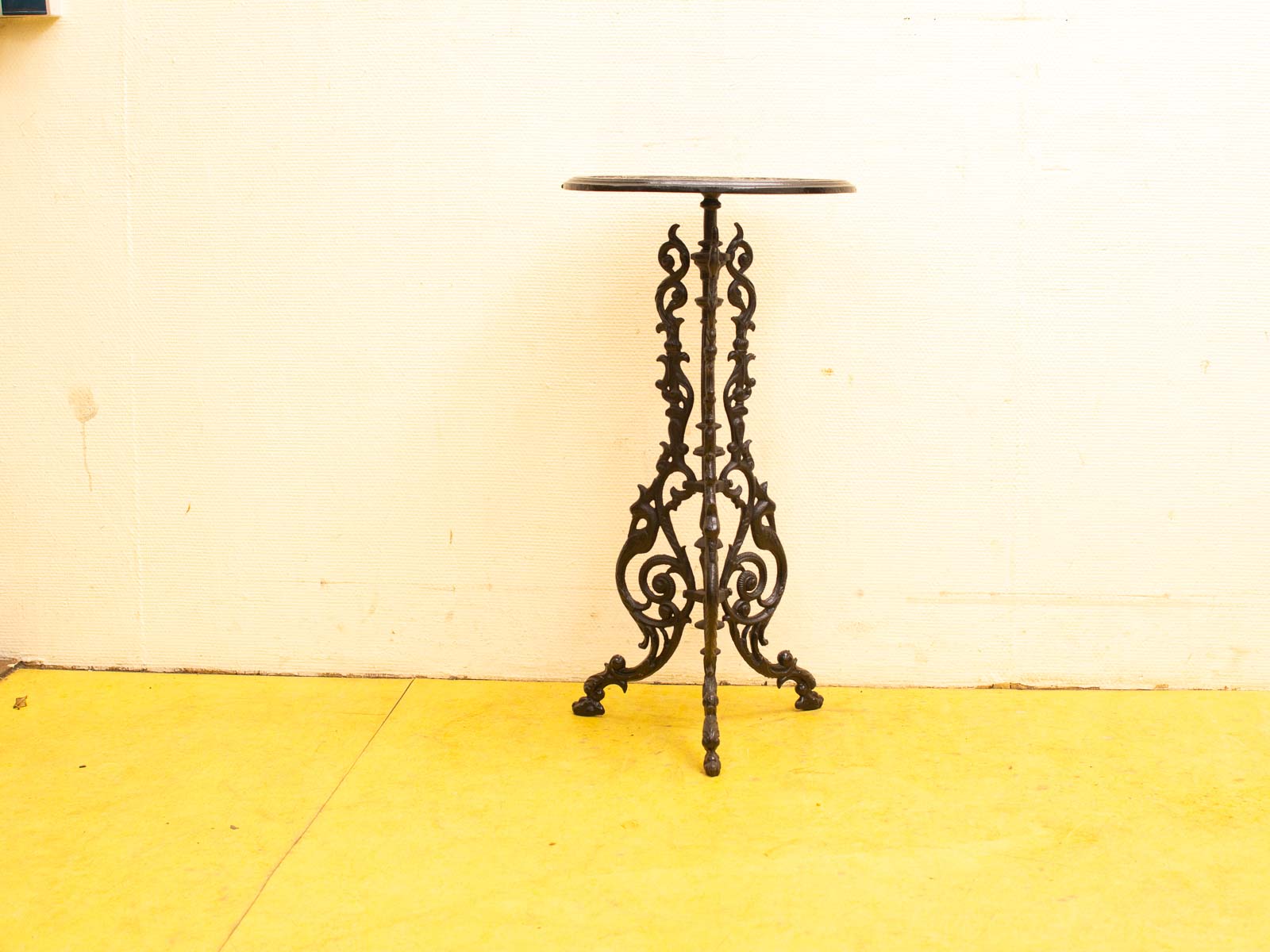 Elegant vintage iron side table with ornate details, perfect for enhancing any interior style.