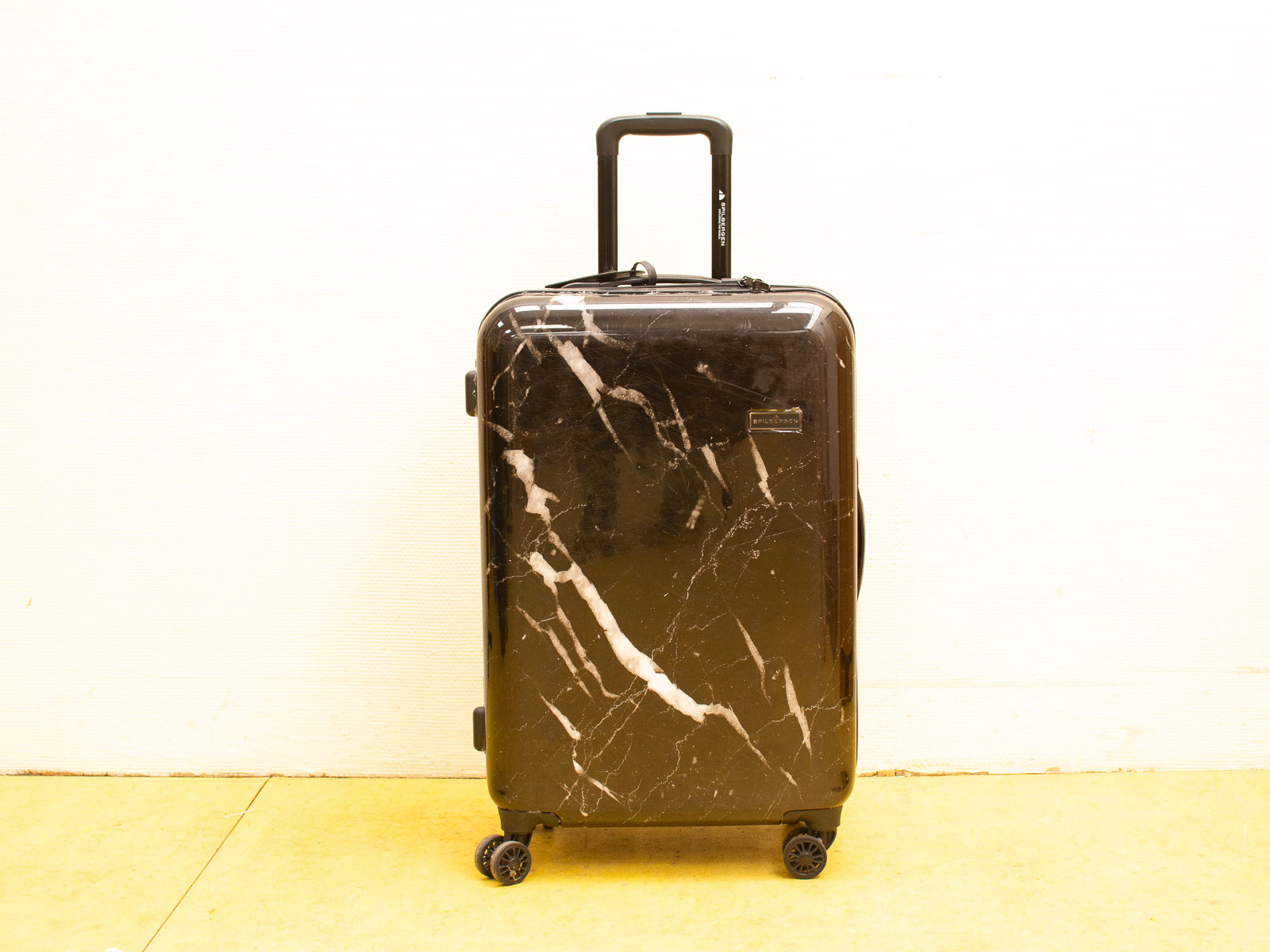 Sleek black marble suitcase for stylish luxury travel, combining elegance with practicality and durability.