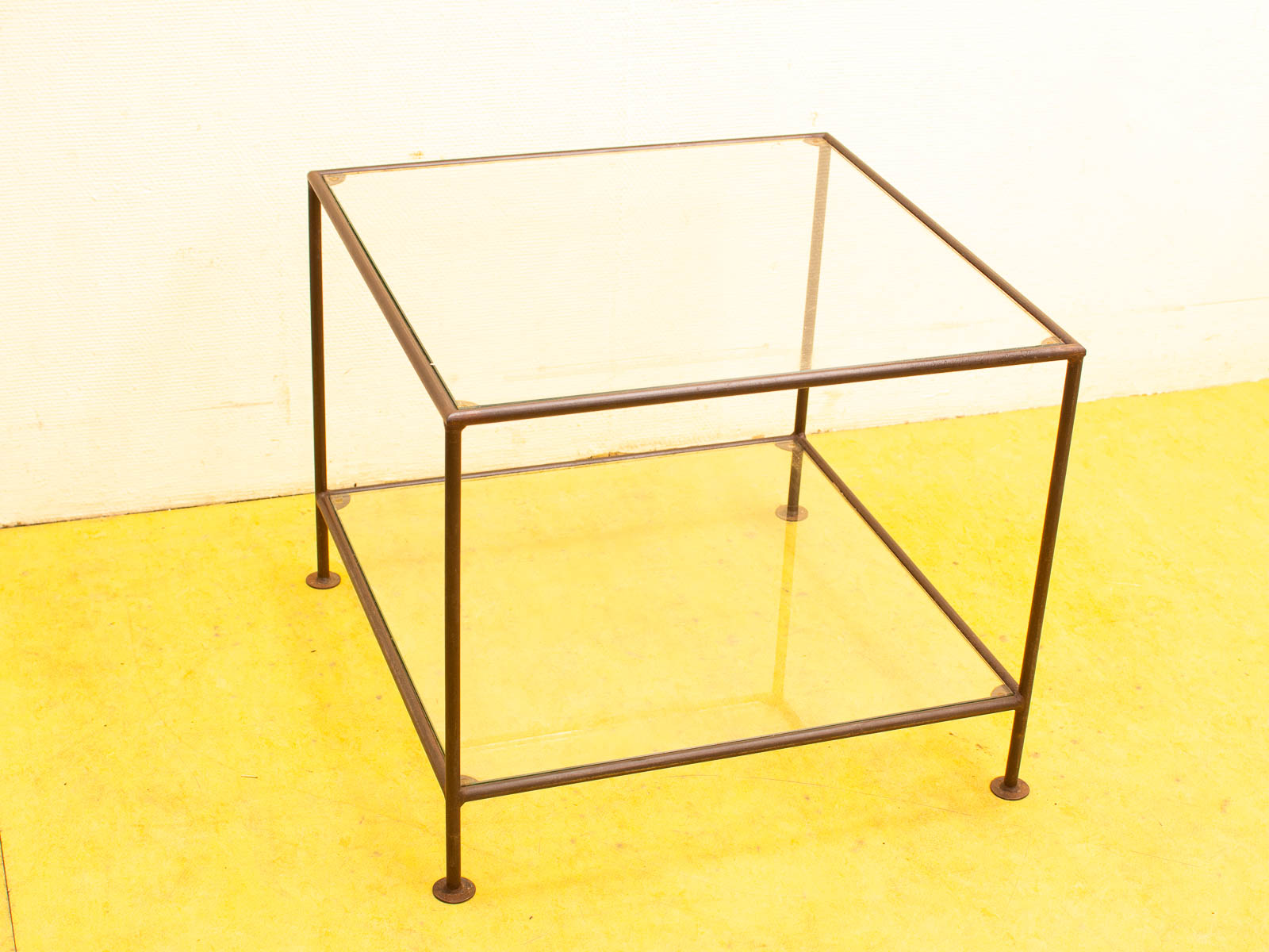 Stylish glass side table with metal frame, perfect for modern living spaces and versatile decor.