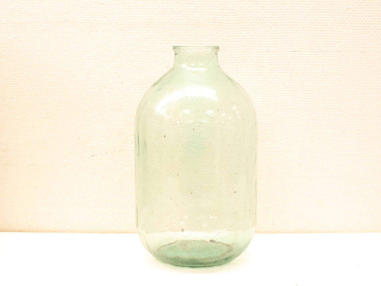 Vintage green glass jar with a unique bulbous shape, perfect for decor or storage.