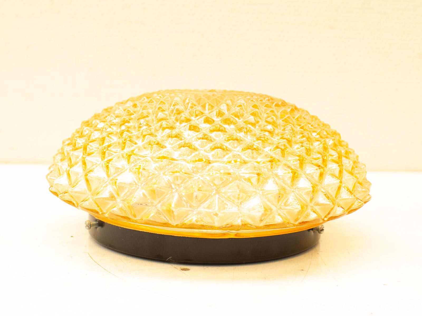 Vintage yellow glass lamp with unique pineapple texture, perfect for collectors and elegant decor.