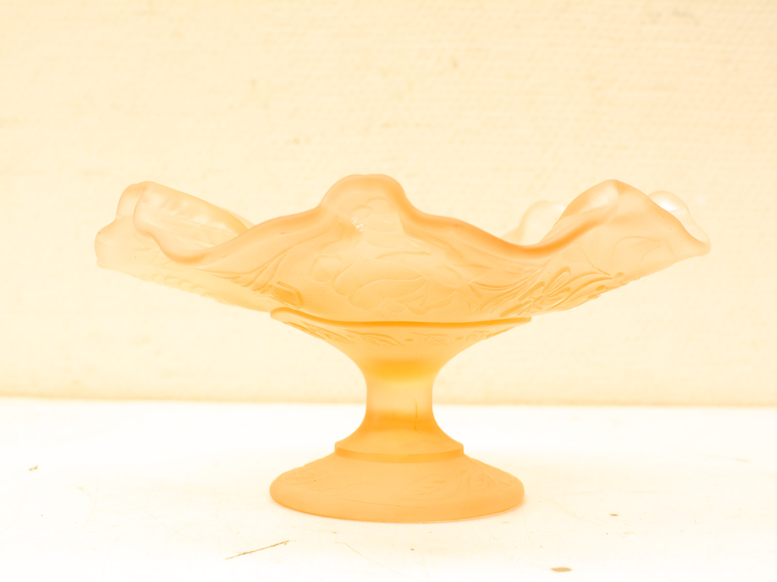 Elegant amber glass flower dish with intricate patterns, perfect for decor or serving treats.