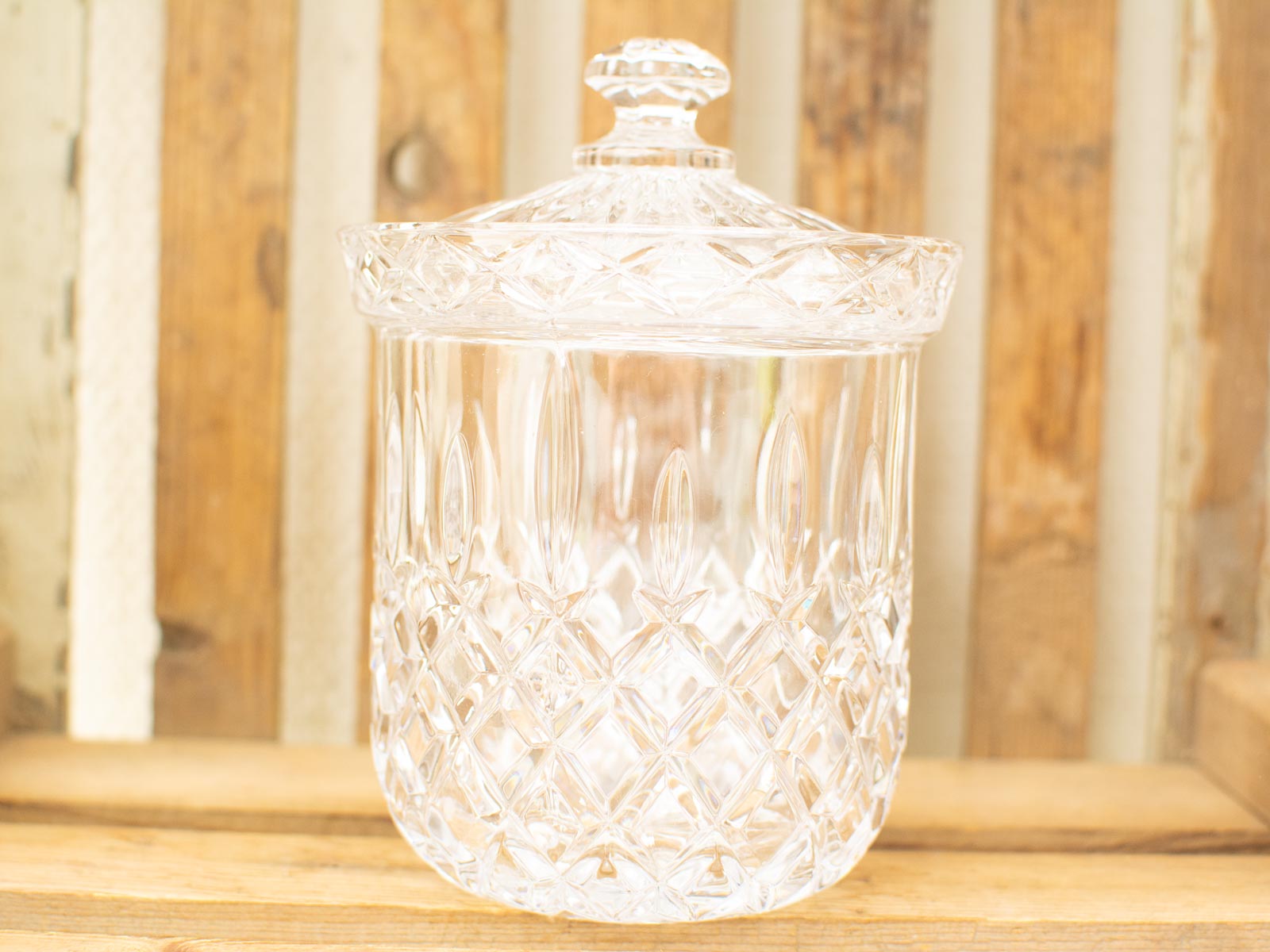 Elegant vintage glass jar with lid, perfect for storage or as a decorative accent.