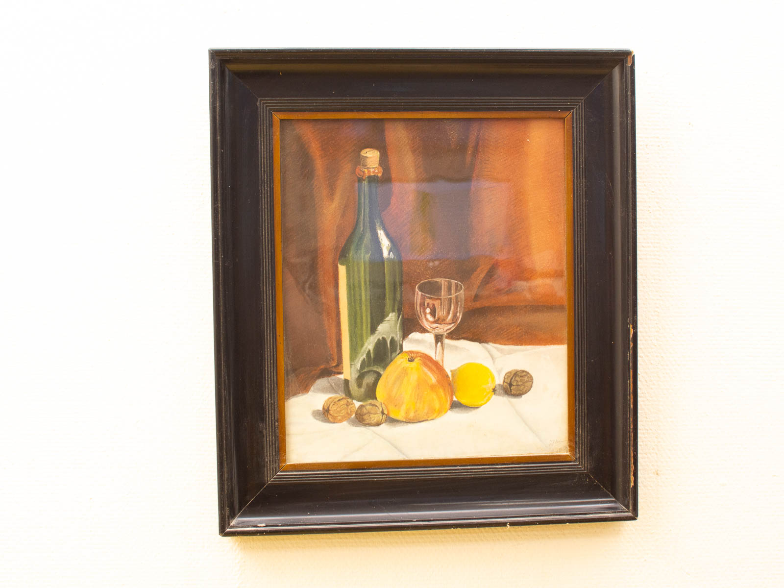 Elegant still life with a green bottle, fruit, and warm colors for inviting home decor.