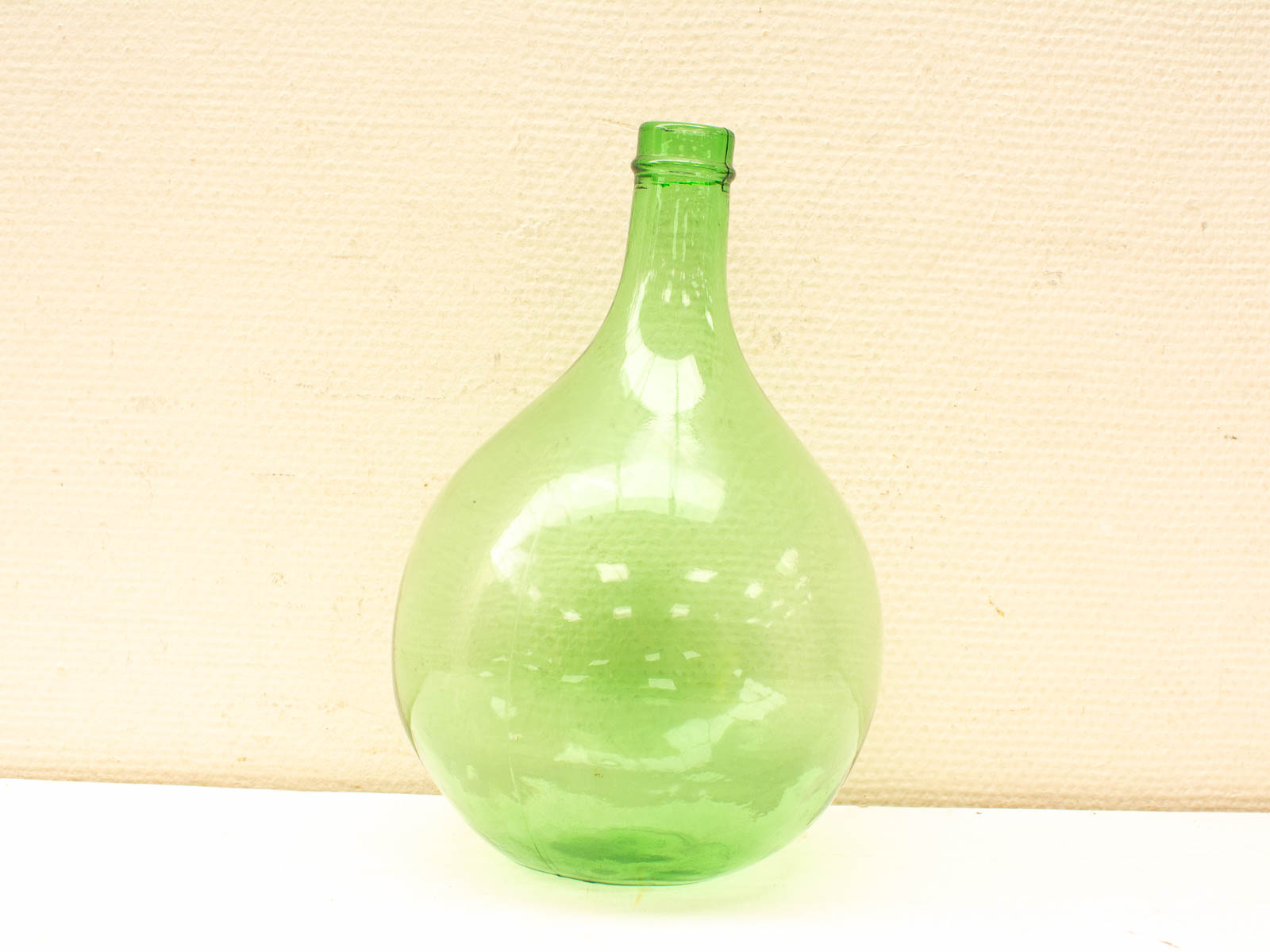 Elegant green glass bottle with a unique gourd shape, perfect for decor and serving.