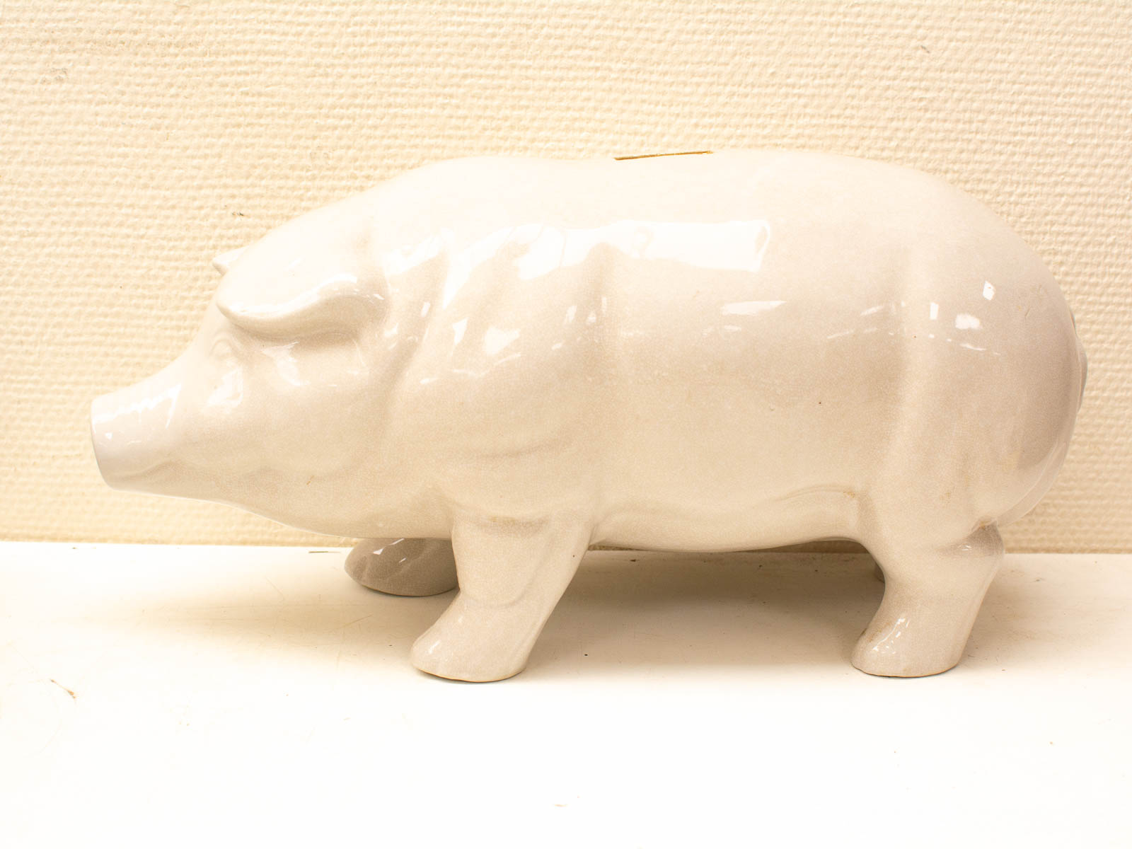 Charming white porcelain piggy bank with vintage style, perfect for decor and saving money.