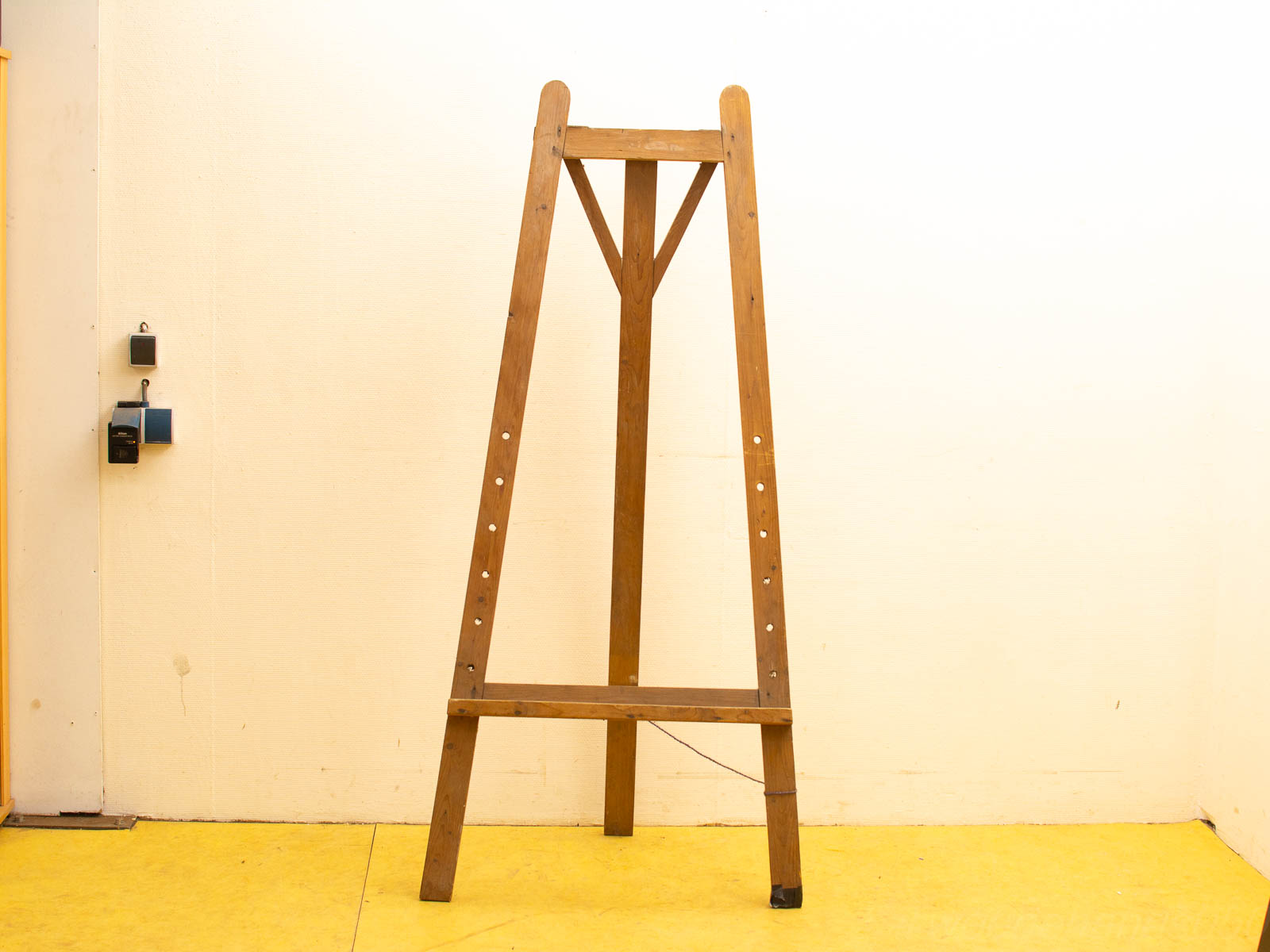 Vintage wooden easel in a vibrant workspace, inviting creativity and artistic expression.