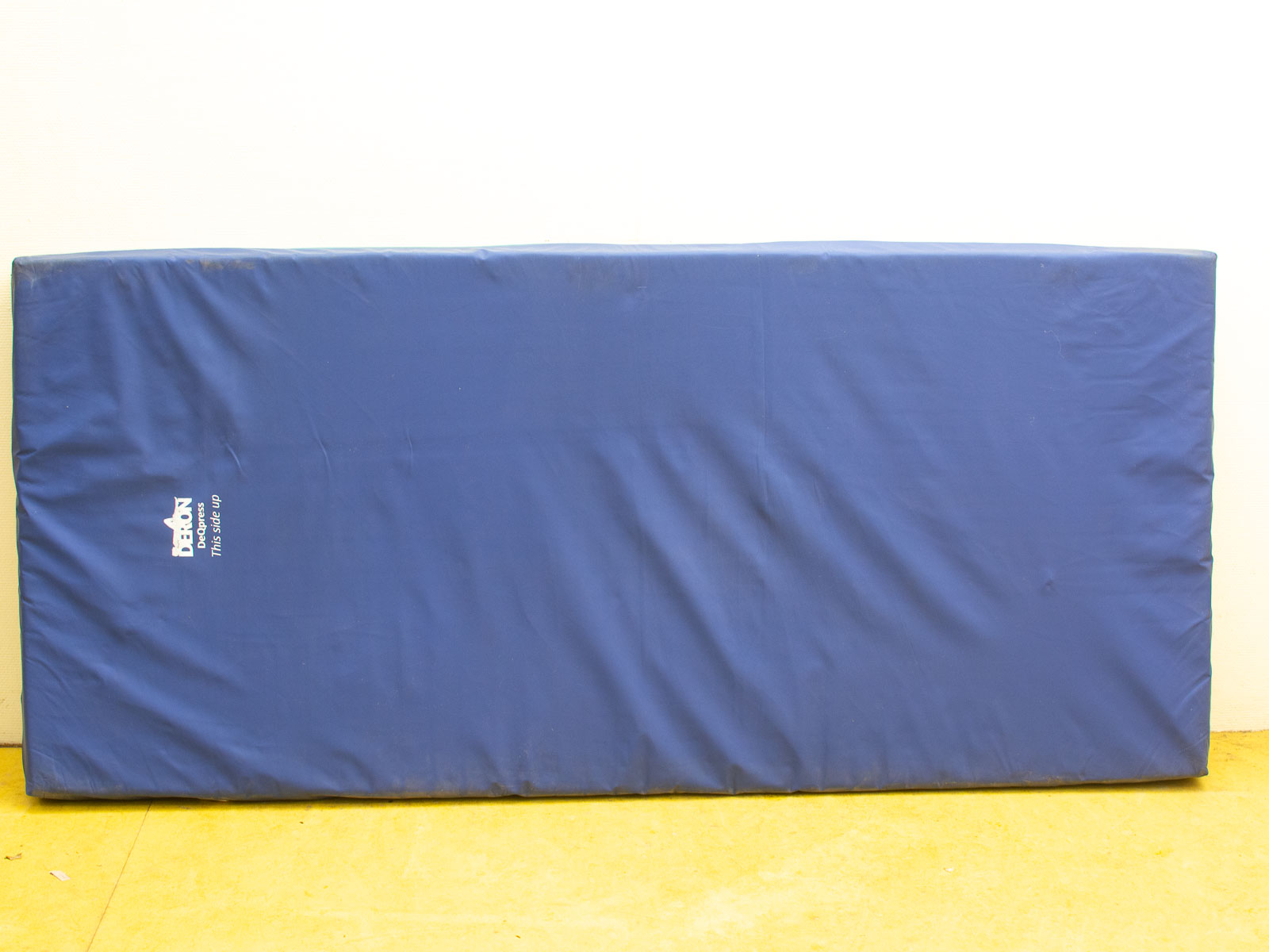 Deep blue Dabron gymnastics mat, high-quality, well-maintained, ideal for safe training activities.