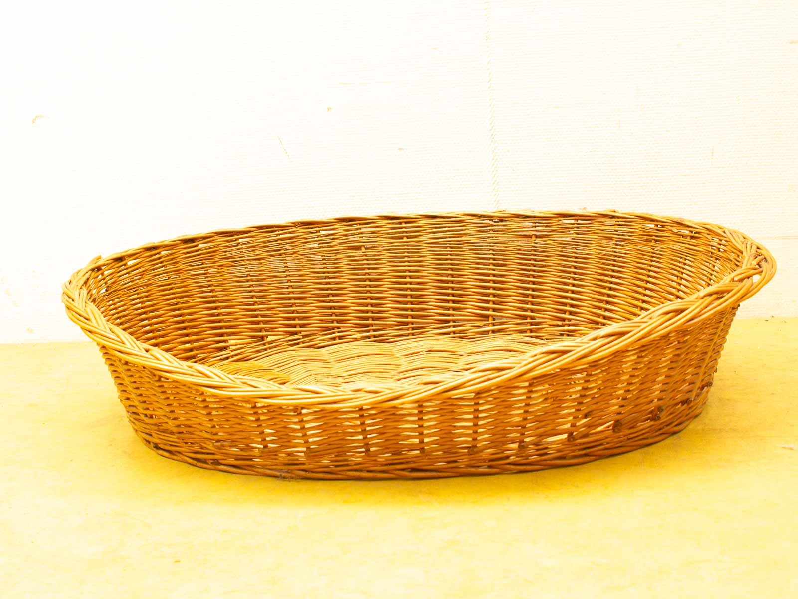 Handwoven oval rattan basket in natural hues, perfect for storage and stylish decor.