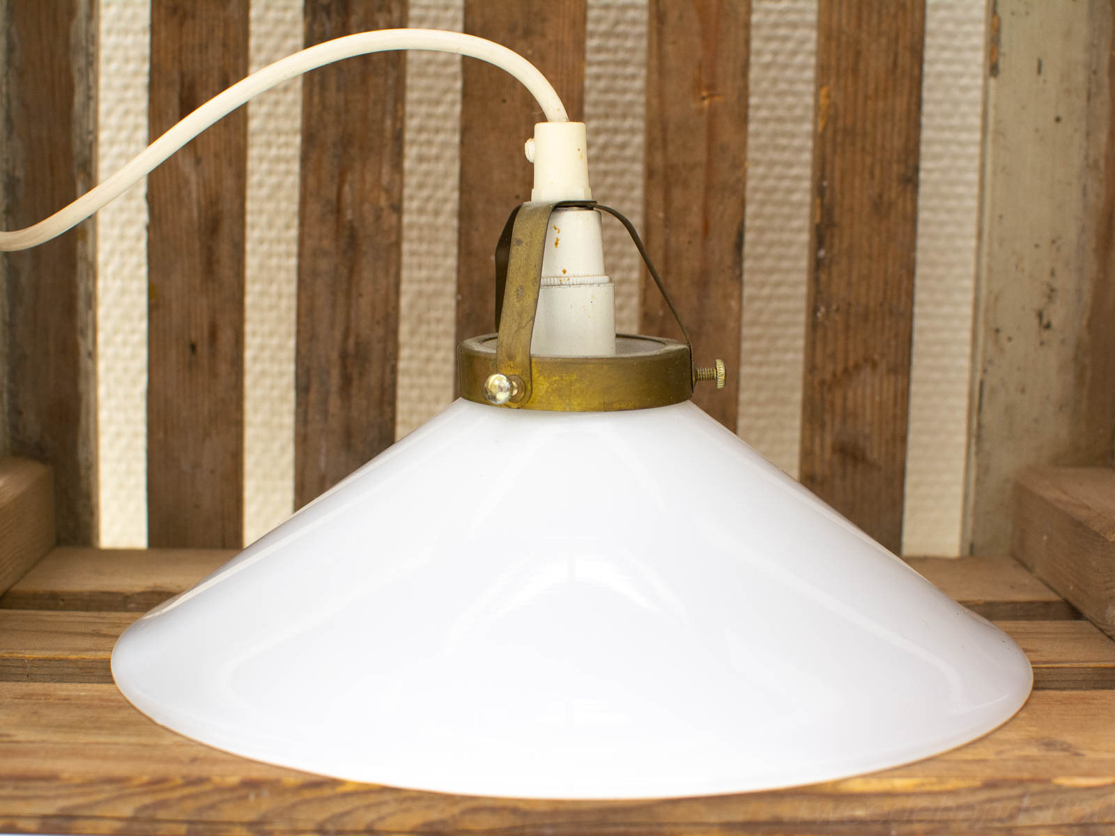 Elegant vintage pendant lamp with glossy white glass shade and aged brass fixture. Perfect for any decor.