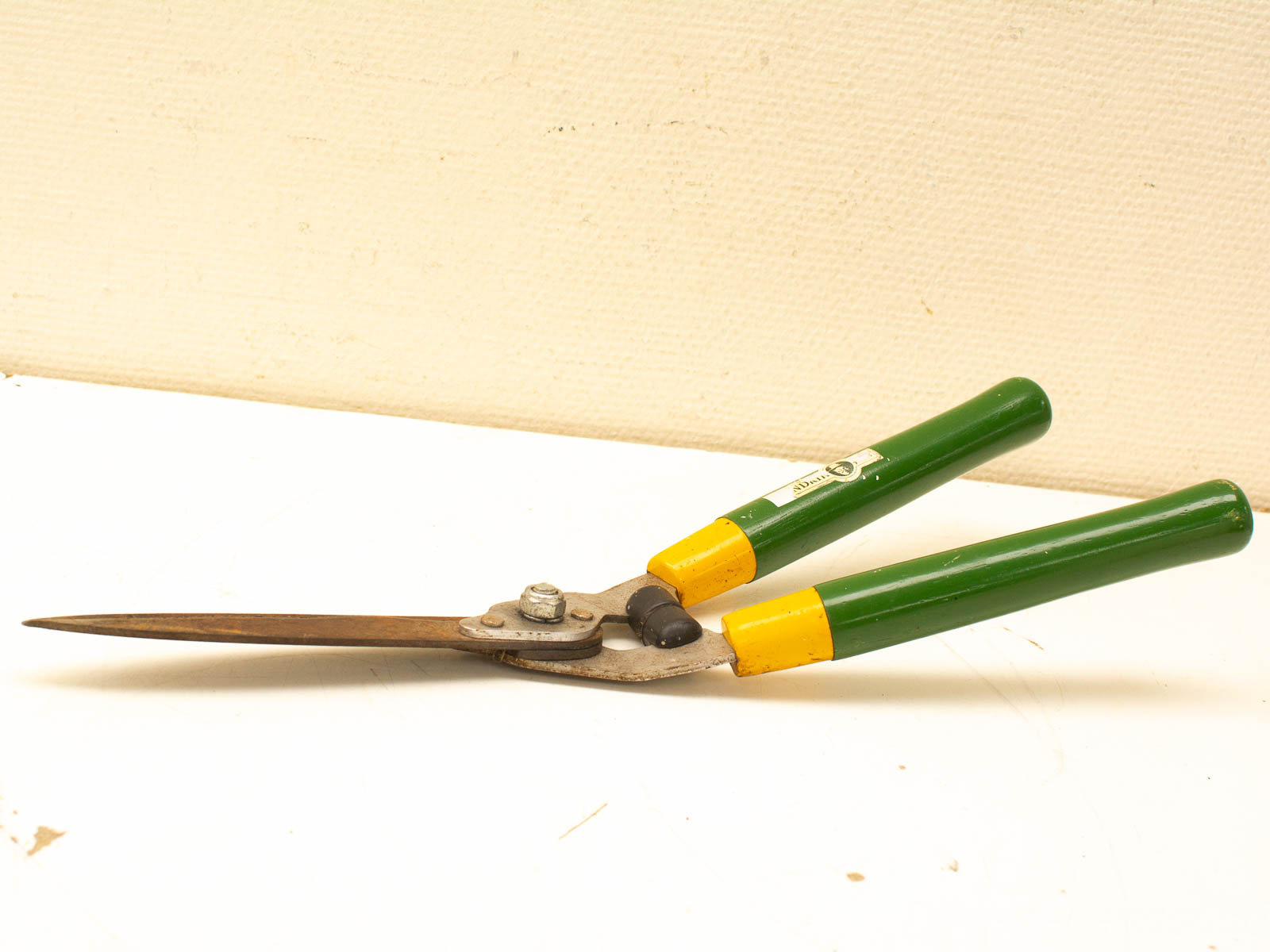 Vintage green and yellow garden shears, ideal for trimming plants with comfort and style.