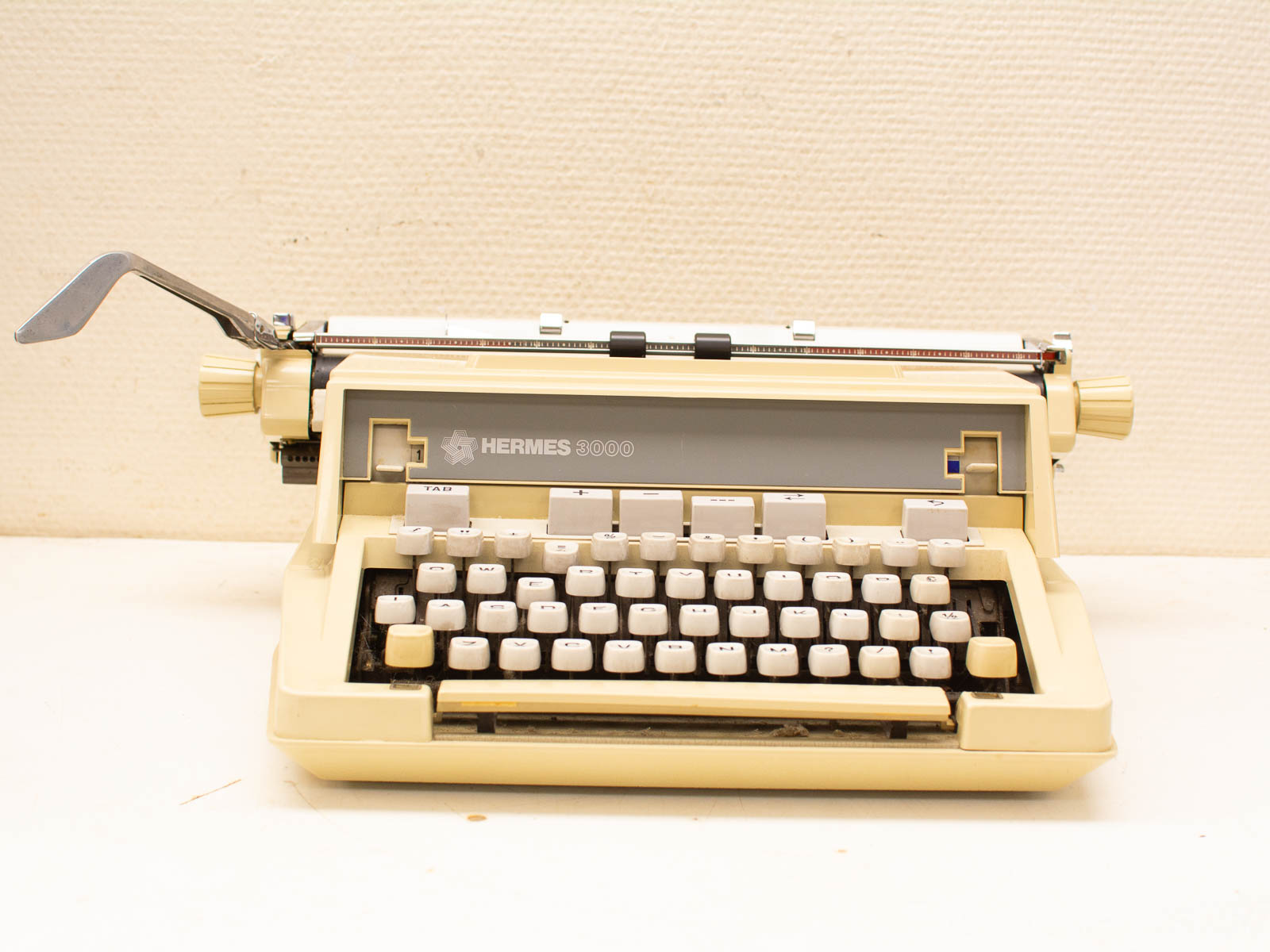 Elegant Hermes 3000 vintage typewriter in ivory, showcasing timeless design and rich writing history.