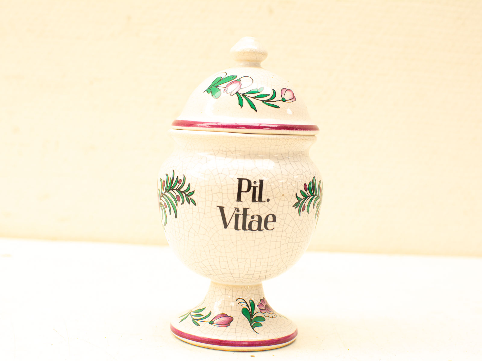 Elegant vintage apothecary jar with floral design and Pil. Vitae inscription, perfect for collectors.