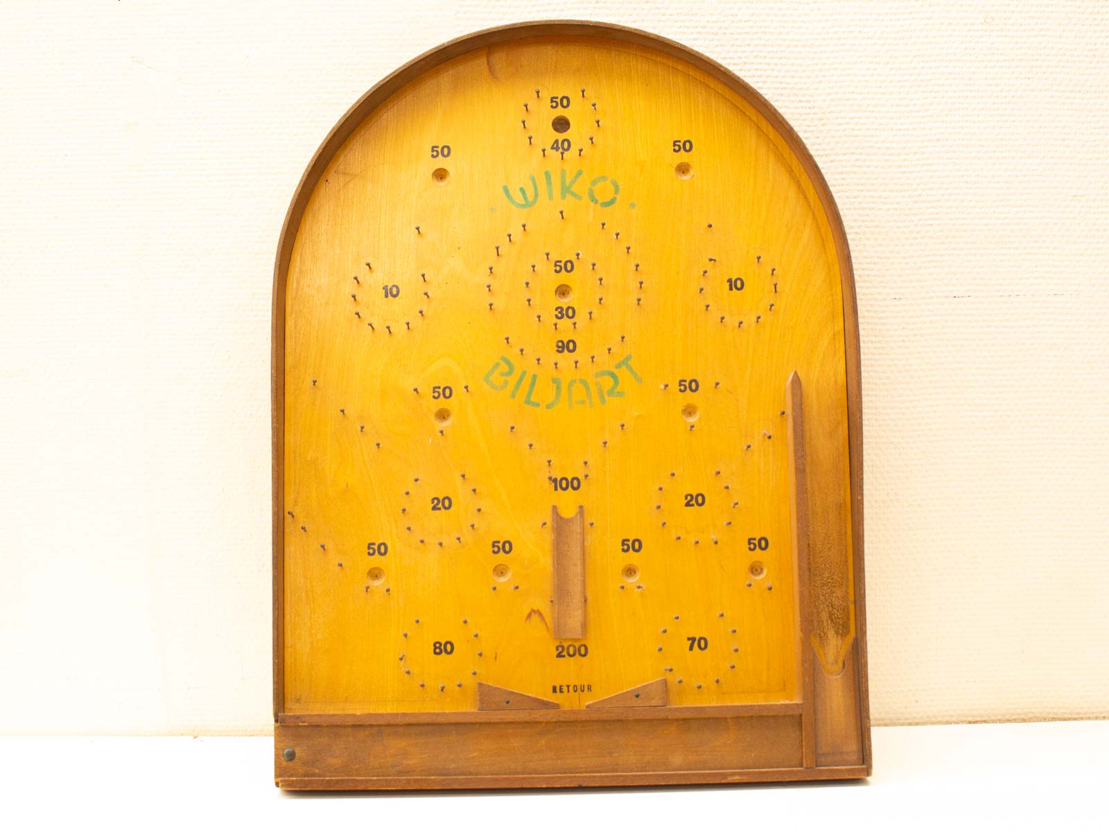 Vintage wooden biljart game board with scoring holes and charming craftsmanship. Perfect for play and display.