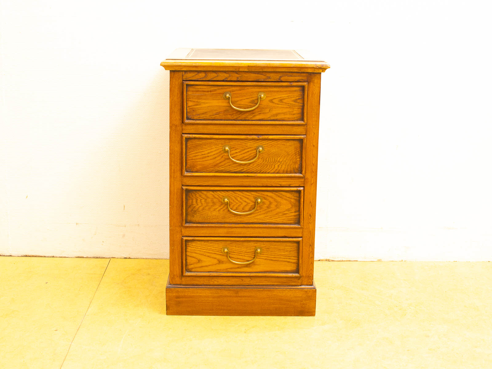 Vintage wooden nightstand with four drawers, warm tone, and timeless design for any decor.