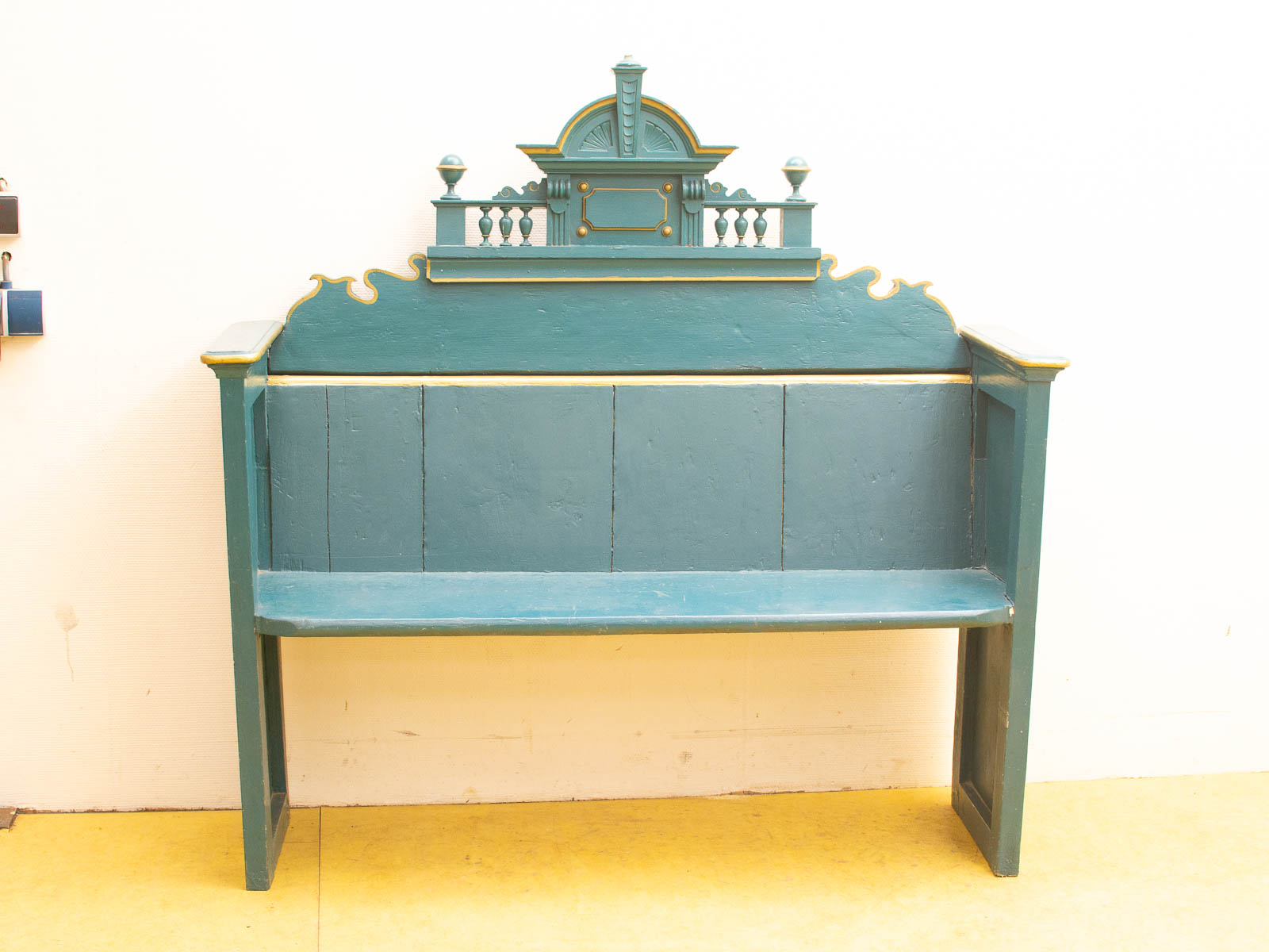 Vintage teal bench with intricate designs, perfect for adding charm to any indoor or outdoor space.