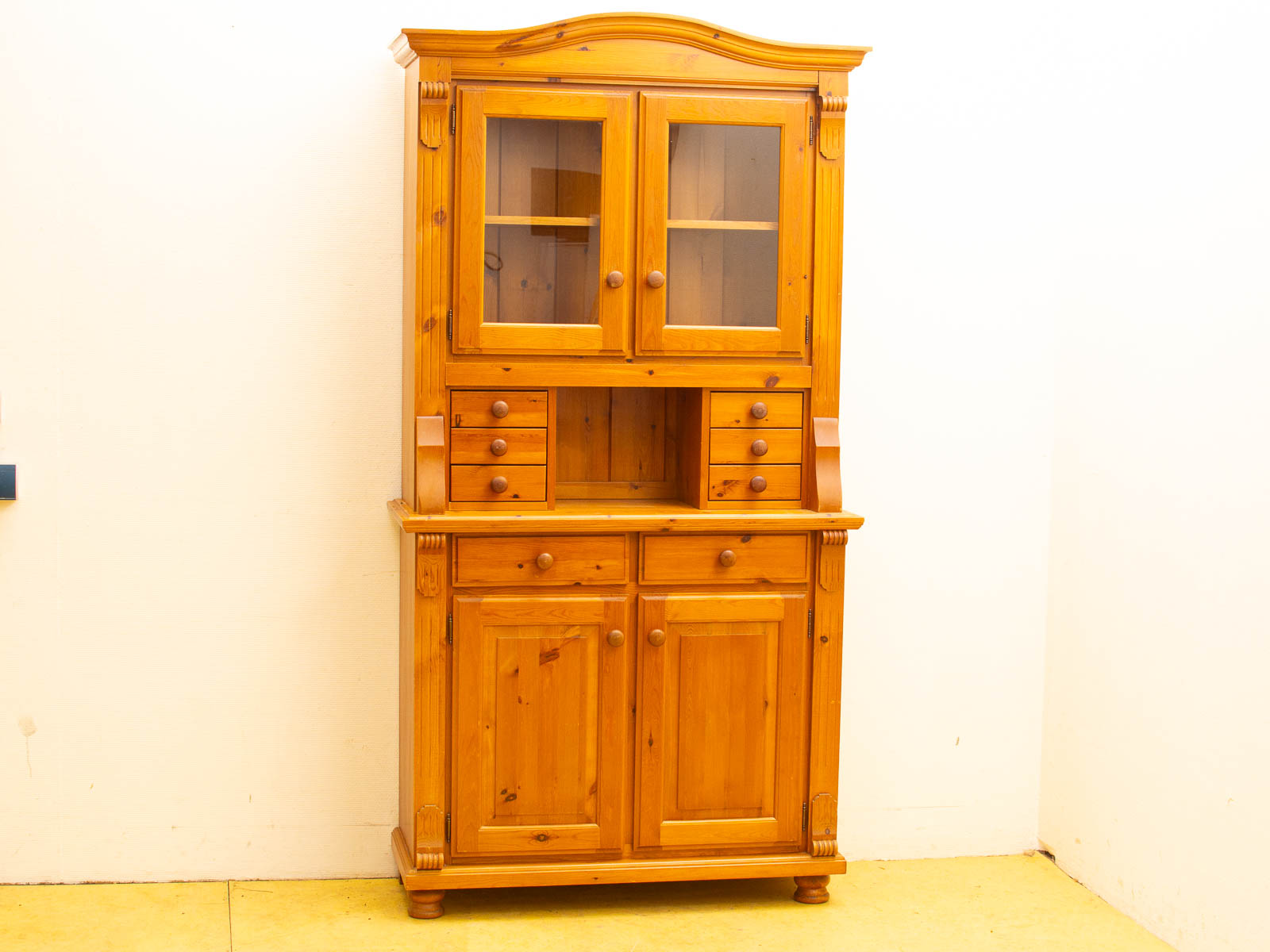 Elegant vintage wooden hutch with glass doors and ample storage for kitchen essentials.