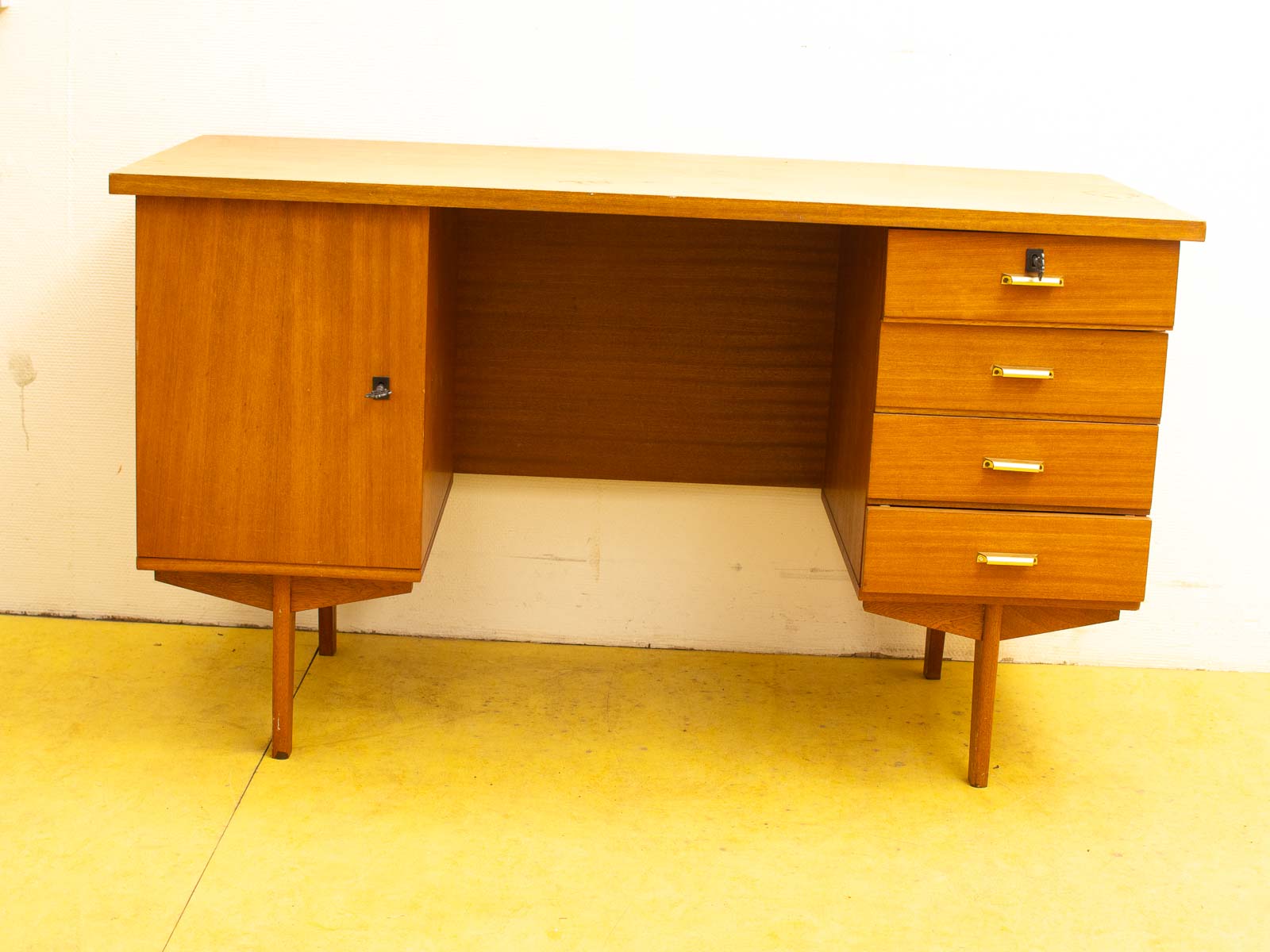 Stylish mid-century modern desk with gold handles and ample storage for any workspace.