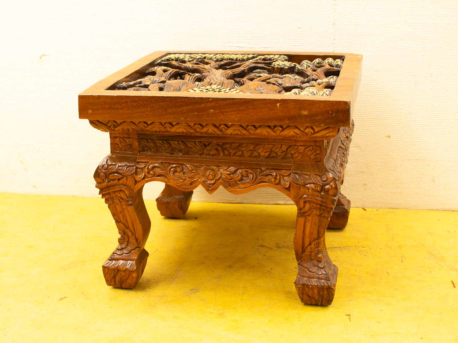 Elegant wooden table with intricate carvings, perfect for enhancing any rooms decor.