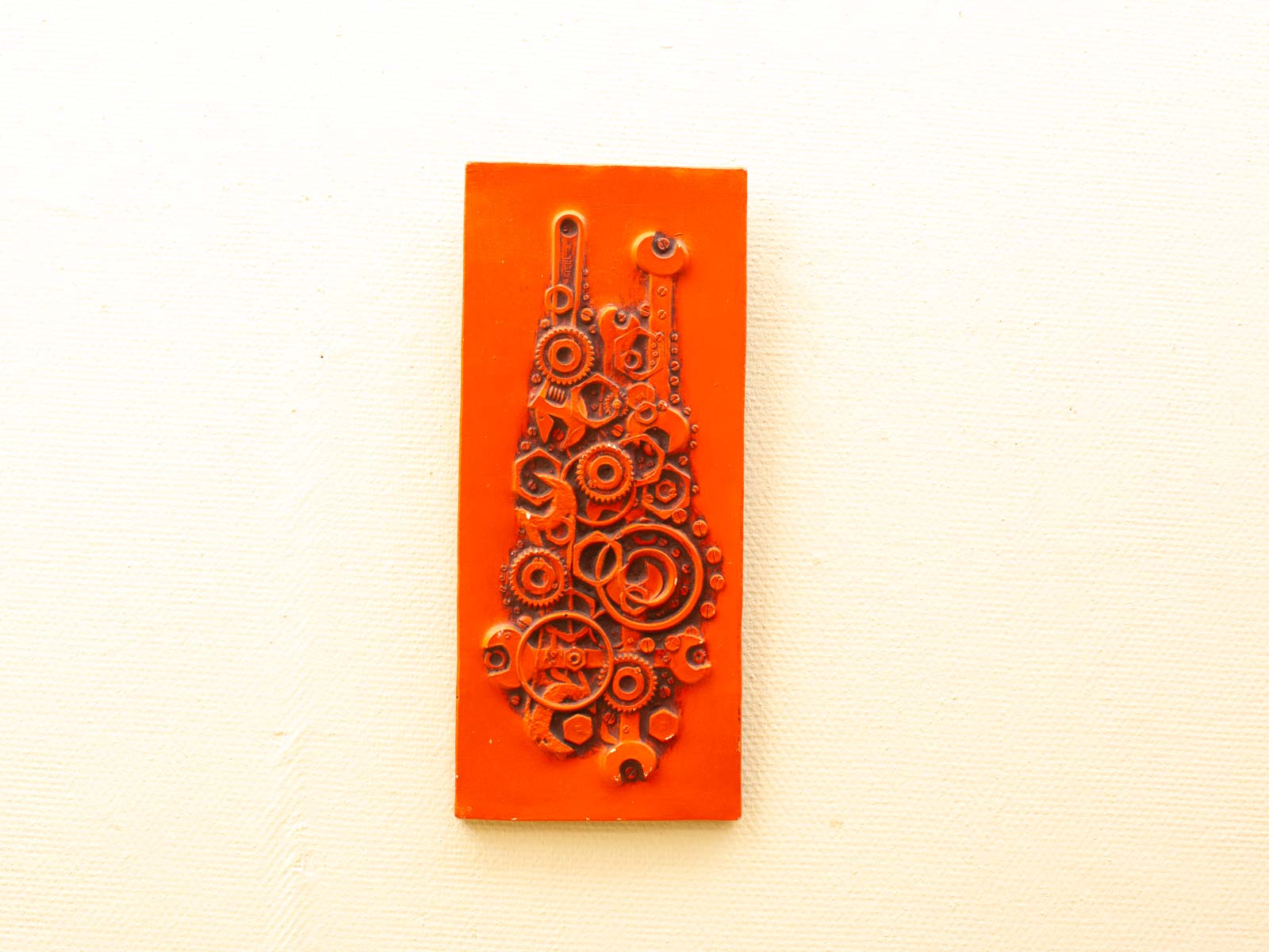 Vibrant orange gears artwork showcasing the beauty of technology and innovative design in mechanics.