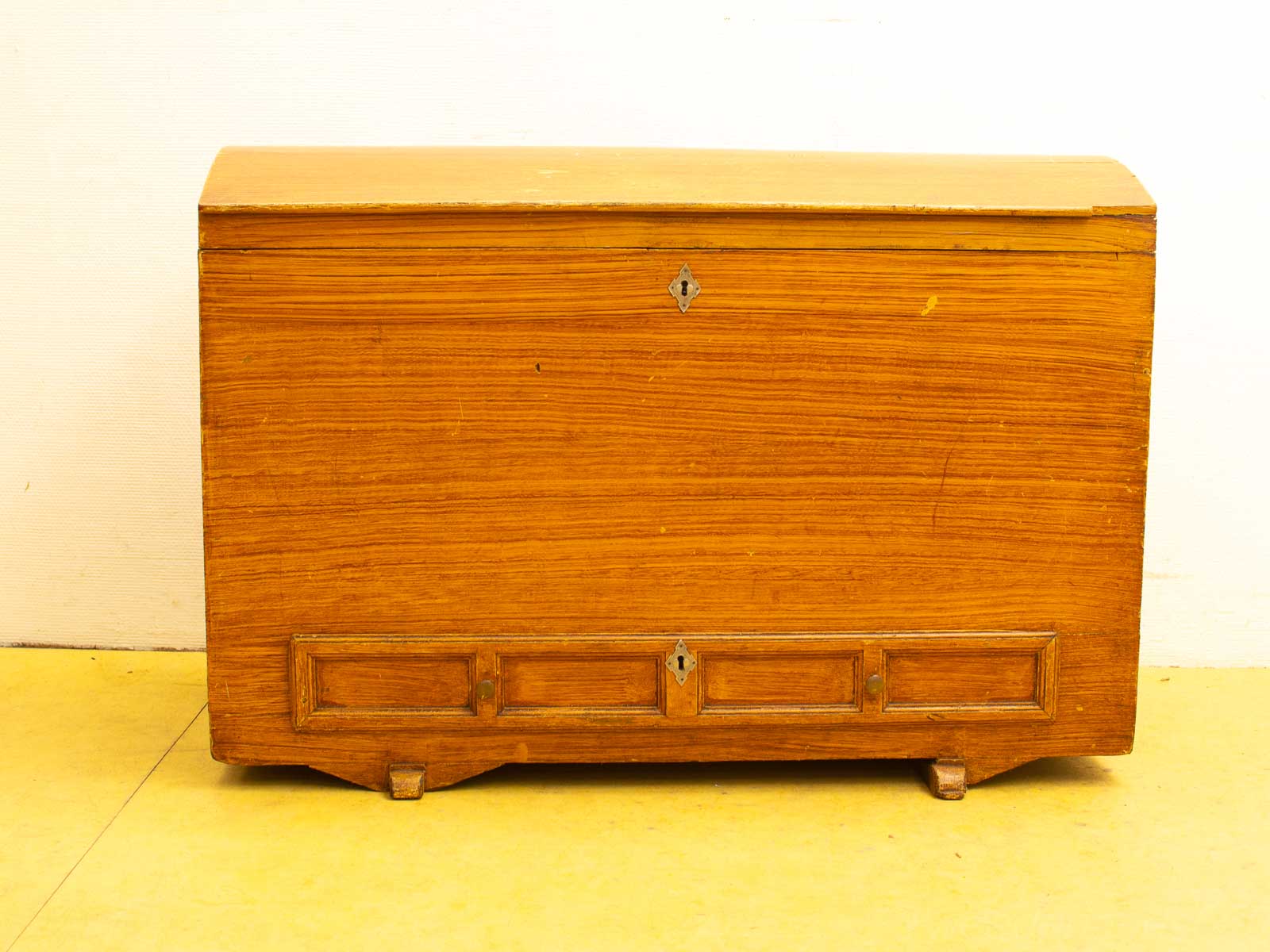 Vintage wooden chest with keyhole, elegant panels, and a warm, timeless design.