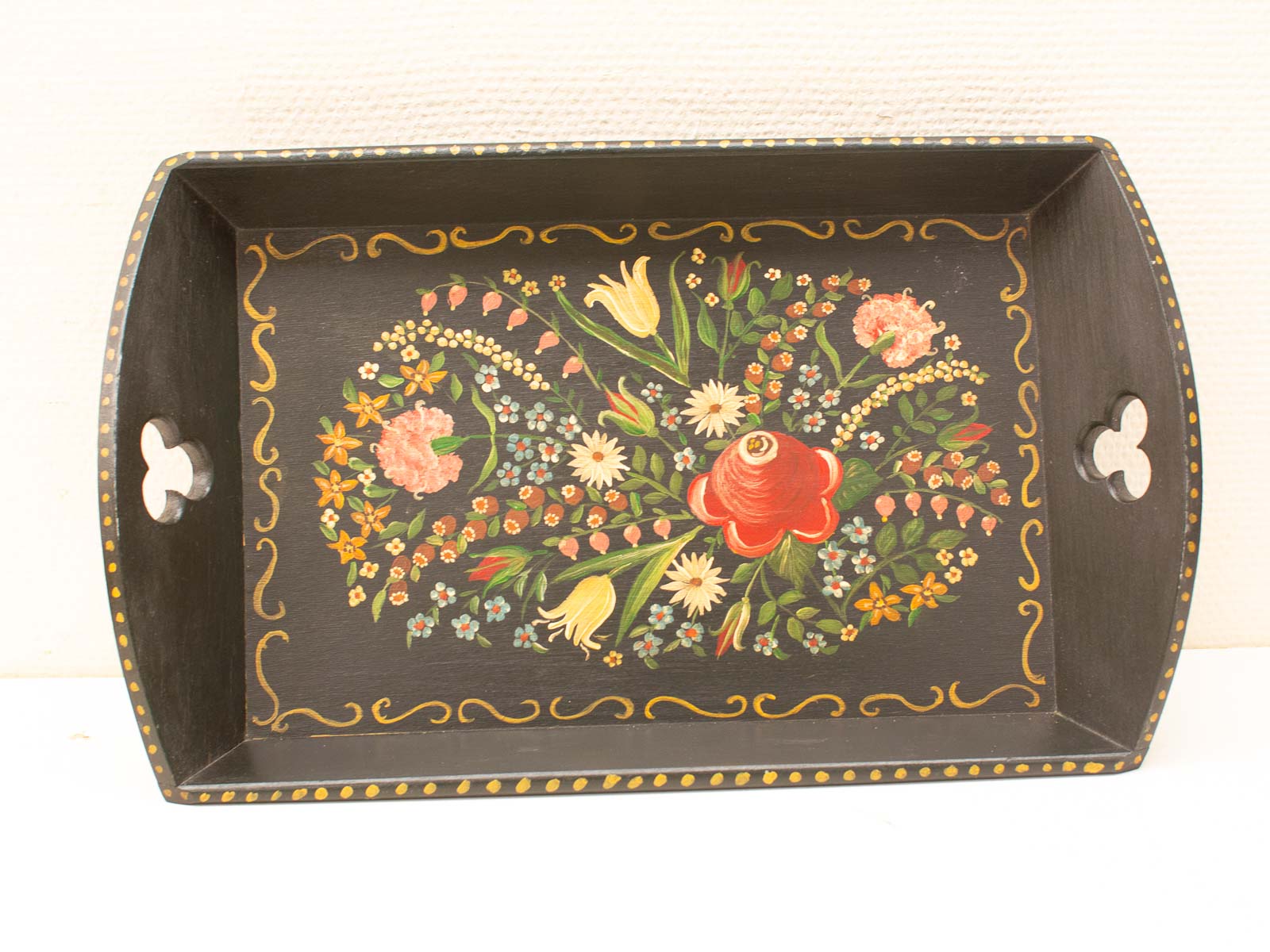 Handcrafted wooden tray with vibrant floral design, perfect for serving or home decor.