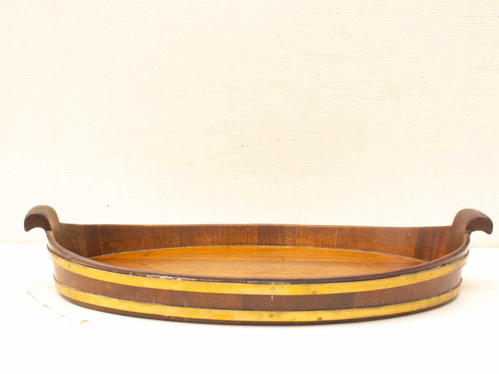 Elegant vintage oval wooden tray with handles, featuring polished dark wood and decorative stripes.