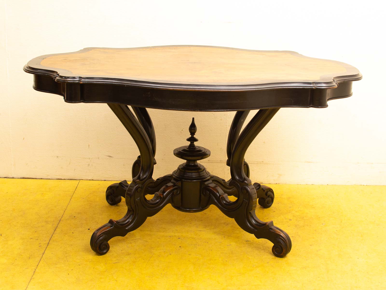 Elegant vintage wooden table with scalloped edge and ornate curved legs, perfect for sophisticated decor.