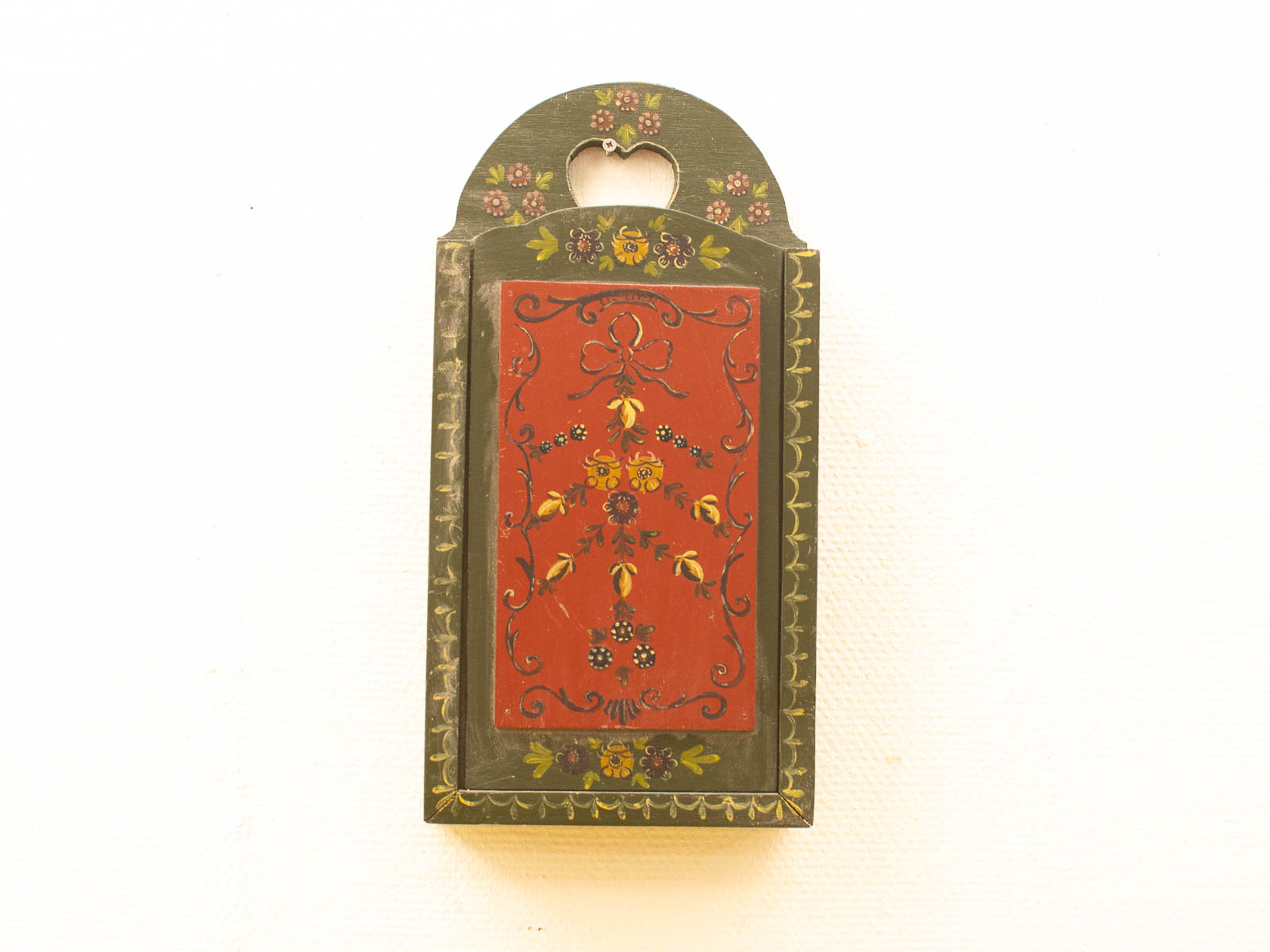 Handcrafted wooden box with vibrant floral designs and heart-shaped cutout, perfect for decor.