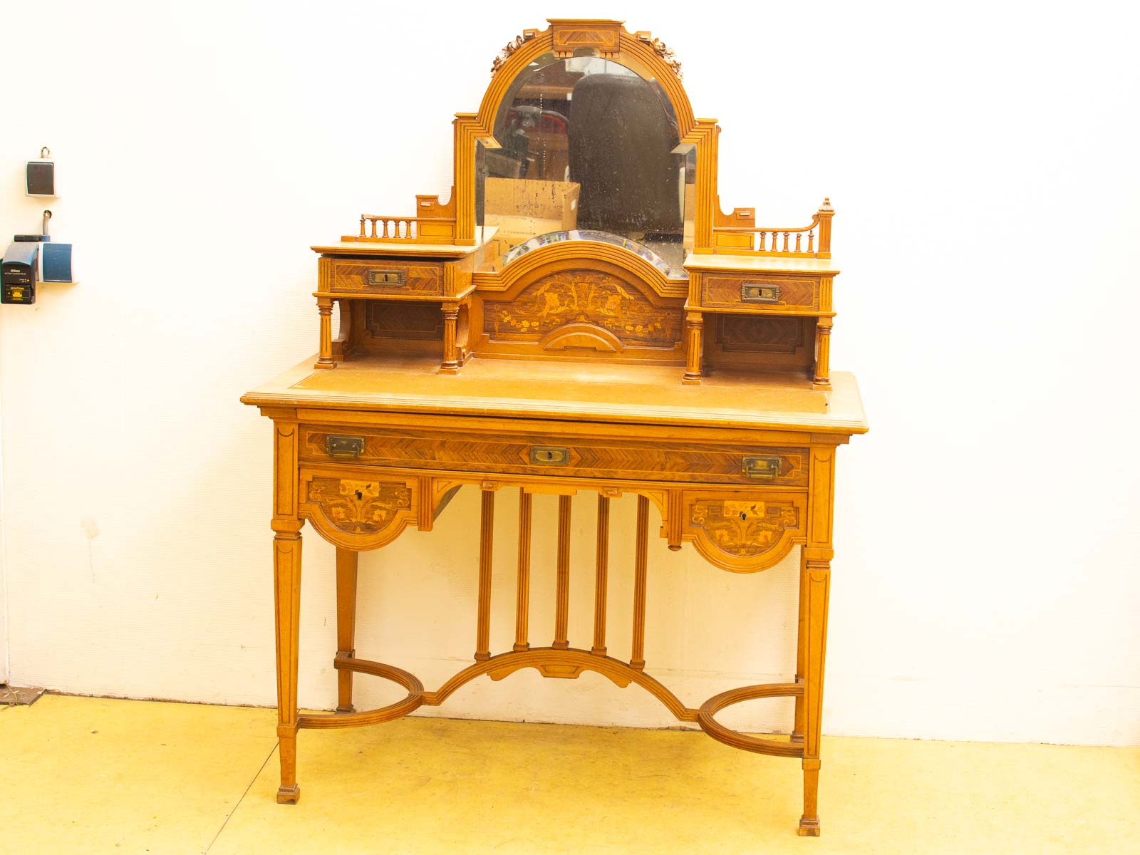 Elegant antique dressing table with ornate mirror and decorative shelves, perfect for any room.