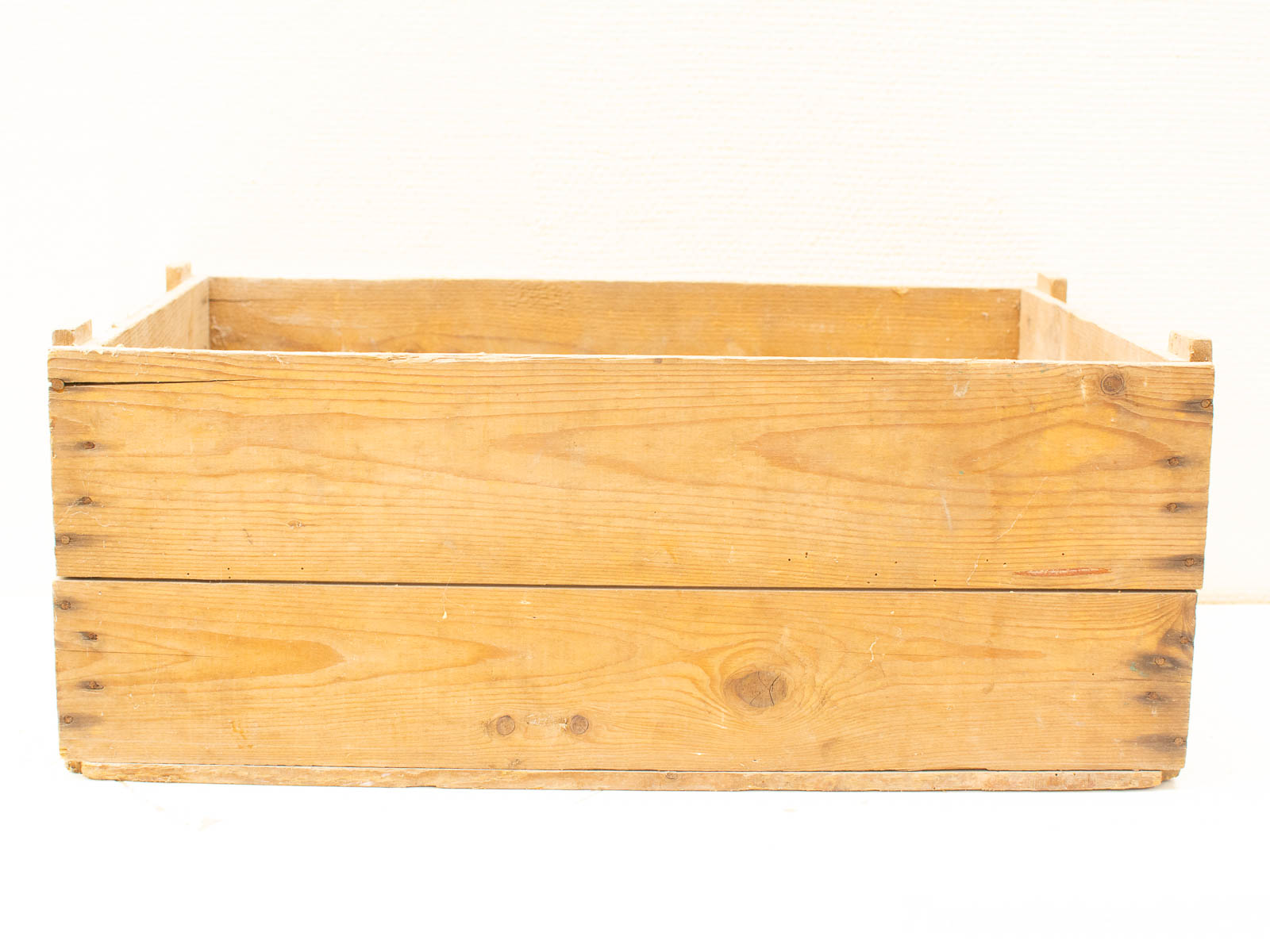 Handmade rustic wooden crate, showcasing natural grain and vintage charm for versatile storage or display.