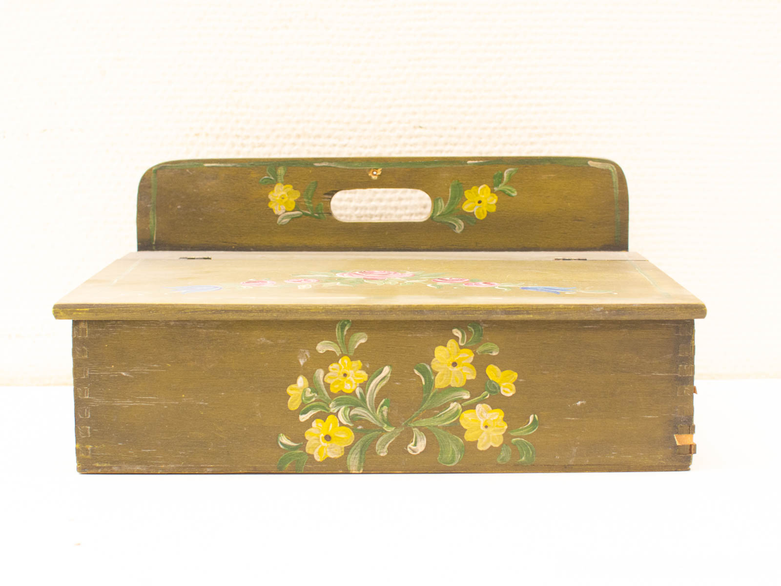 Charming rustic wooden box with hand-painted floral designs, perfect for vintage decor enthusiasts.