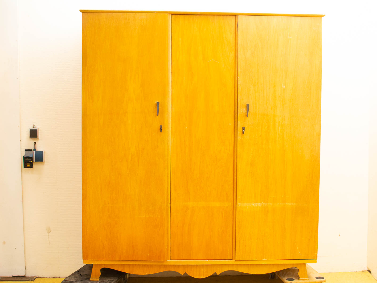 Charming vintage wooden wardrobe with warm finish, elegant design, and nostalgic character.