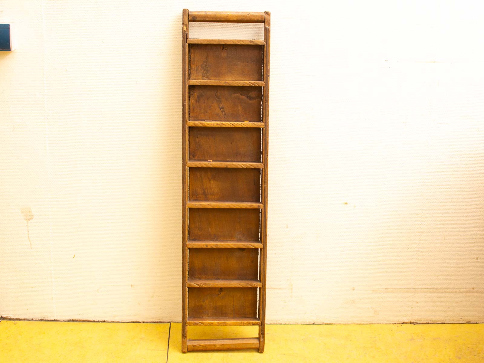 Rustic wooden ladder with eight rungs, perfect for practical use or home decor.