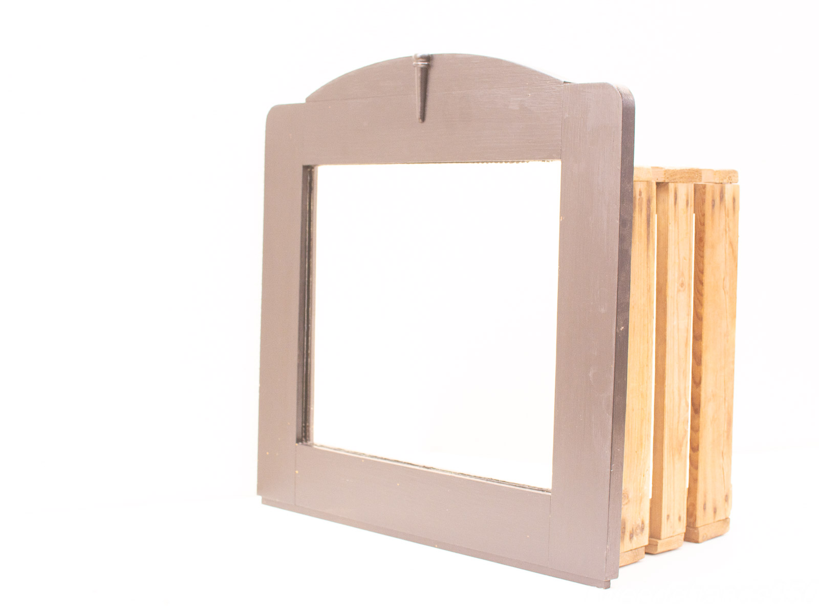 Elegant dark wooden frame with rustic storage slats, perfect for vintage item display.