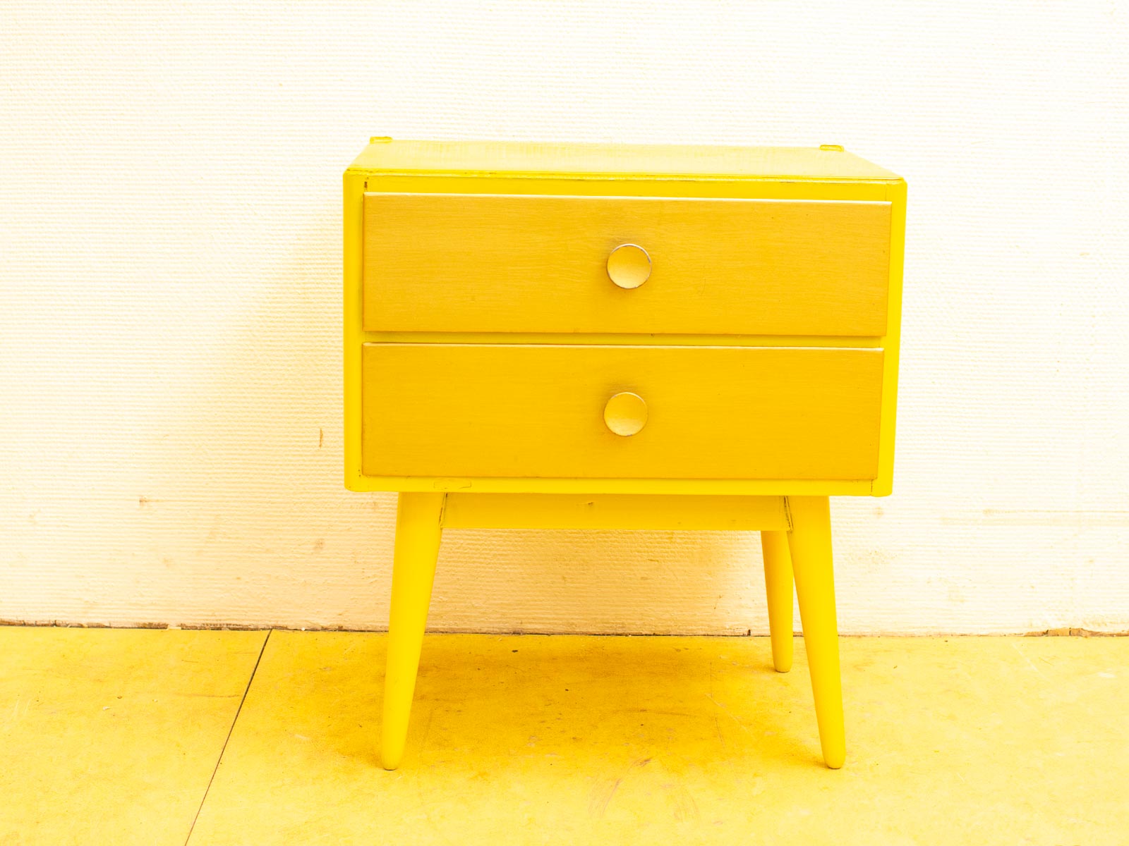 Vibrant yellow minimalist nightstand with two drawers, perfect for modern home decor.