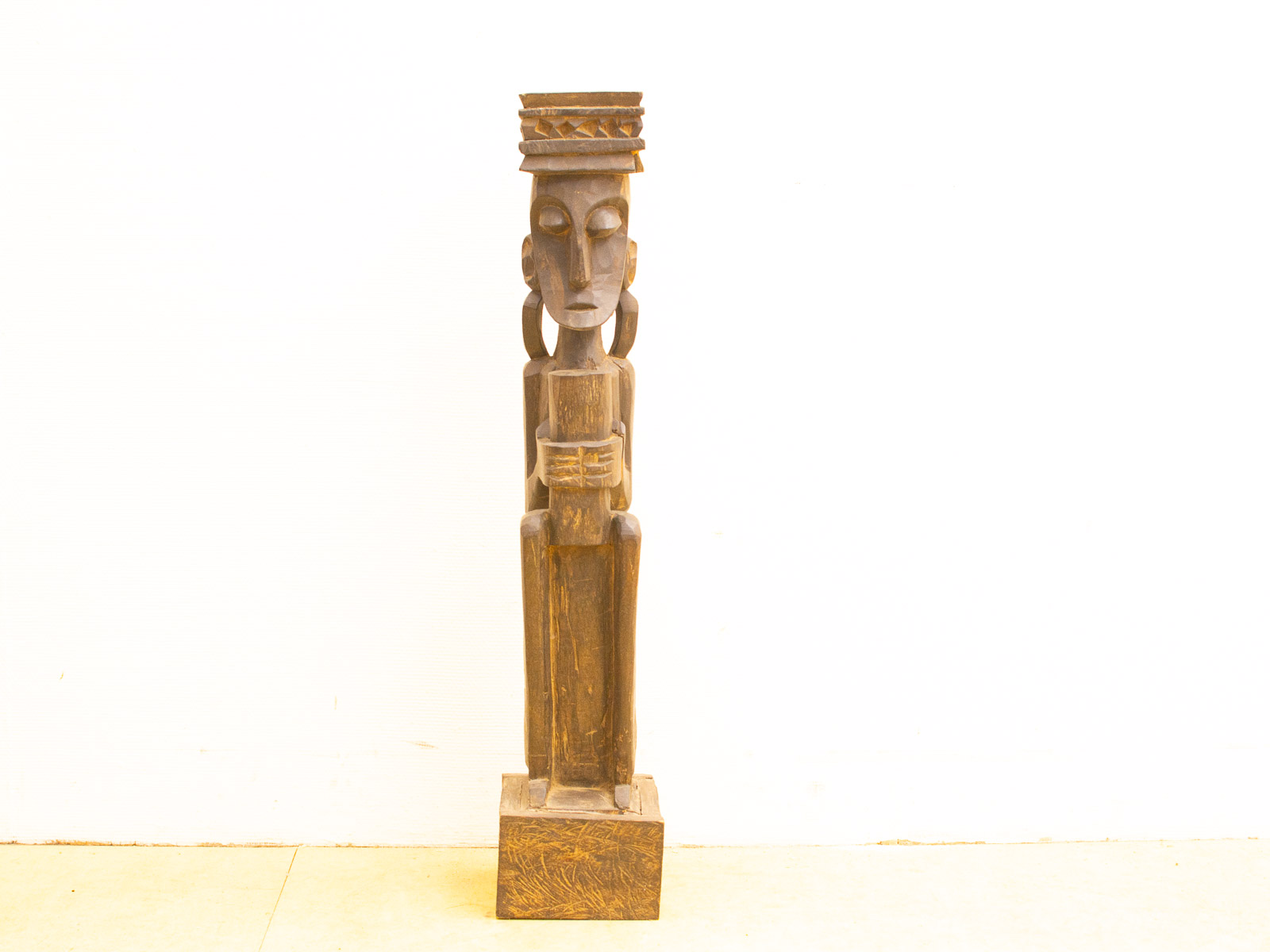 Elegant wooden sculpture with intricate headdress and serene expression, perfect for art enthusiasts.