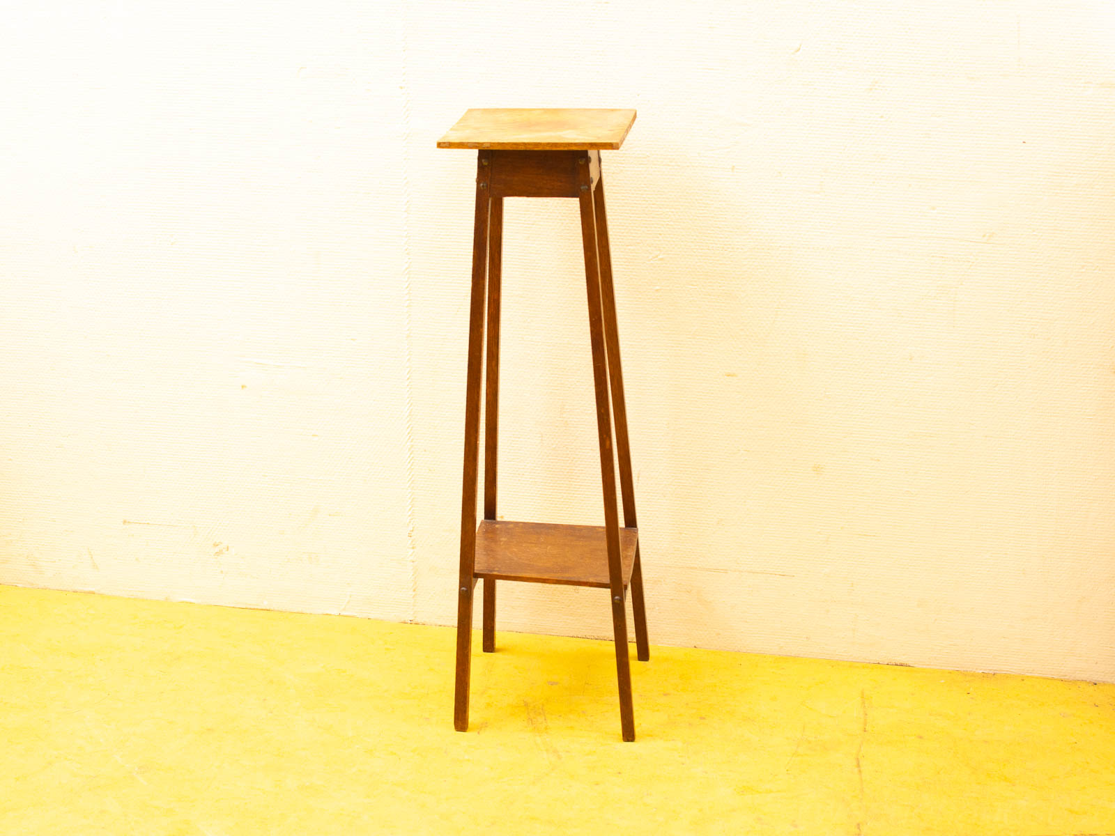 Elegant wooden stand with tapered legs and lower shelf, ideal for vintage decor display.