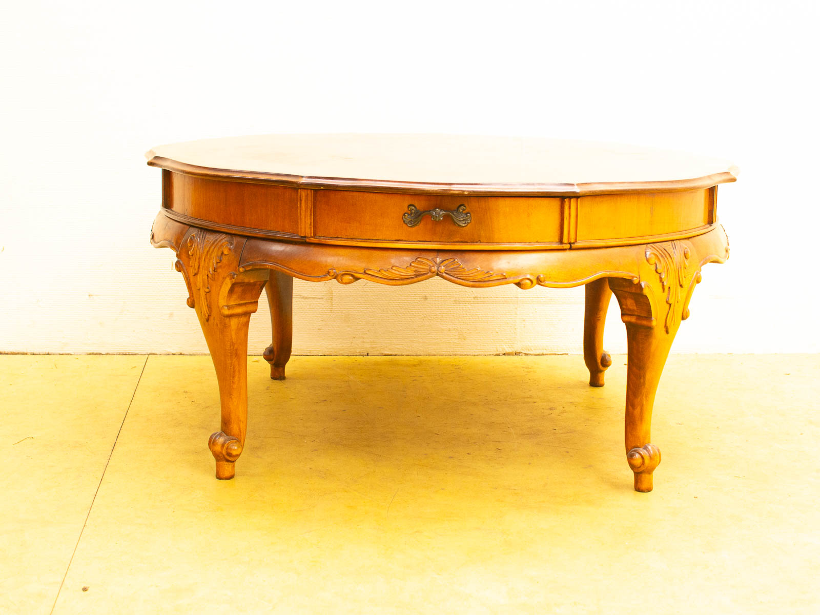 Elegant antique wooden coffee table with drawer, showcasing exquisite craftsmanship and timeless design.