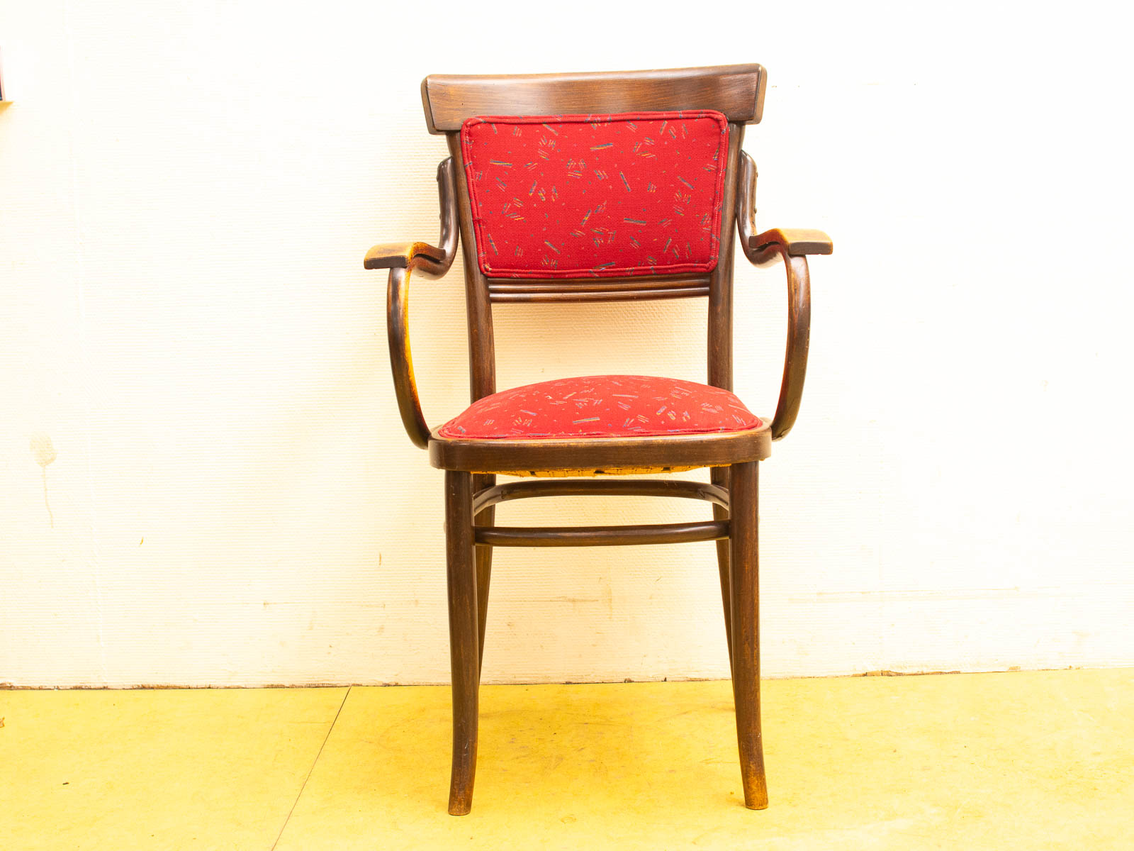 Elegant vintage wooden chair with red upholstery, combining comfort and style for any decor.