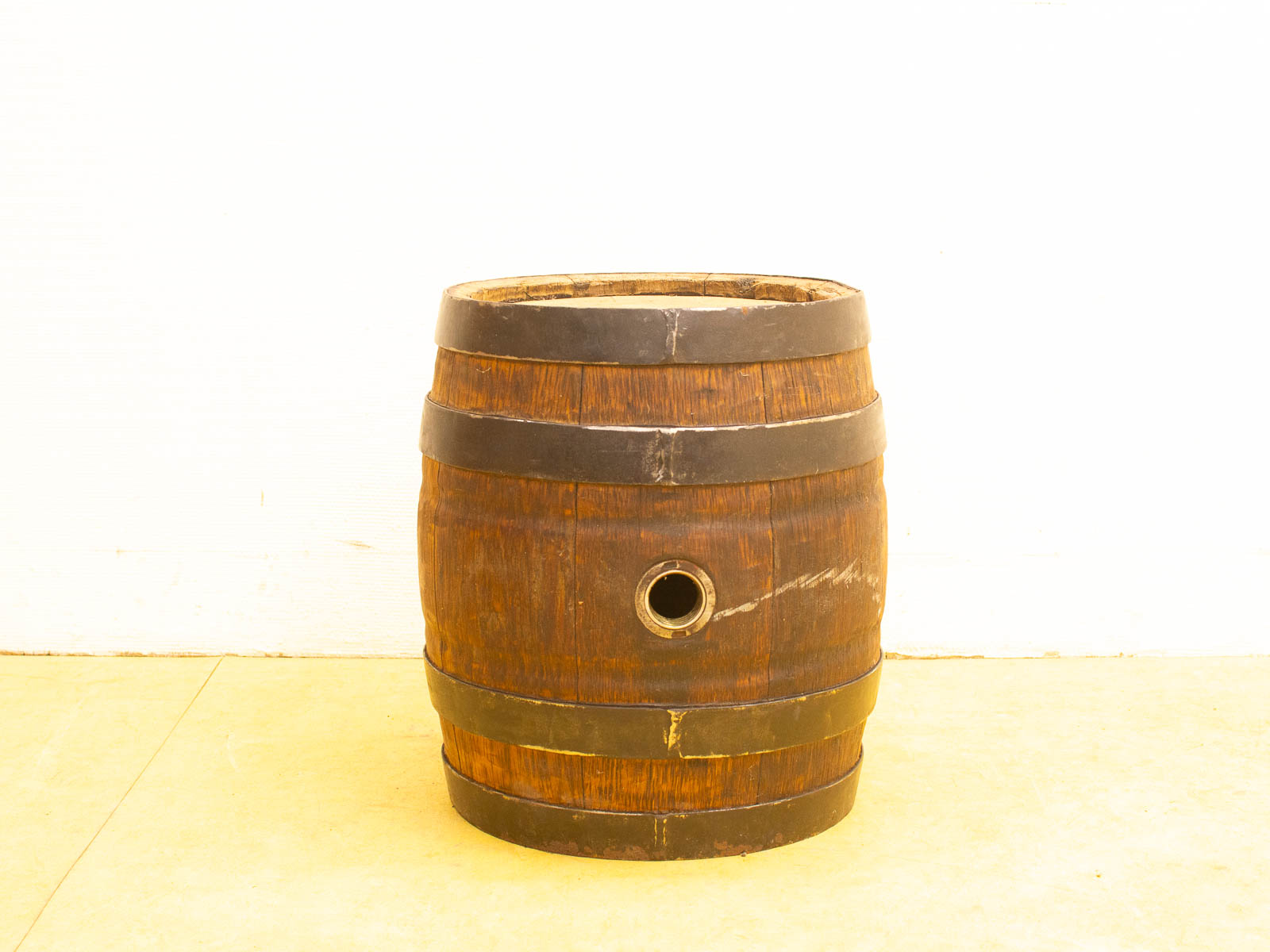 Rustic vintage wooden barrel with metal bands, perfect for storage or unique home decor.